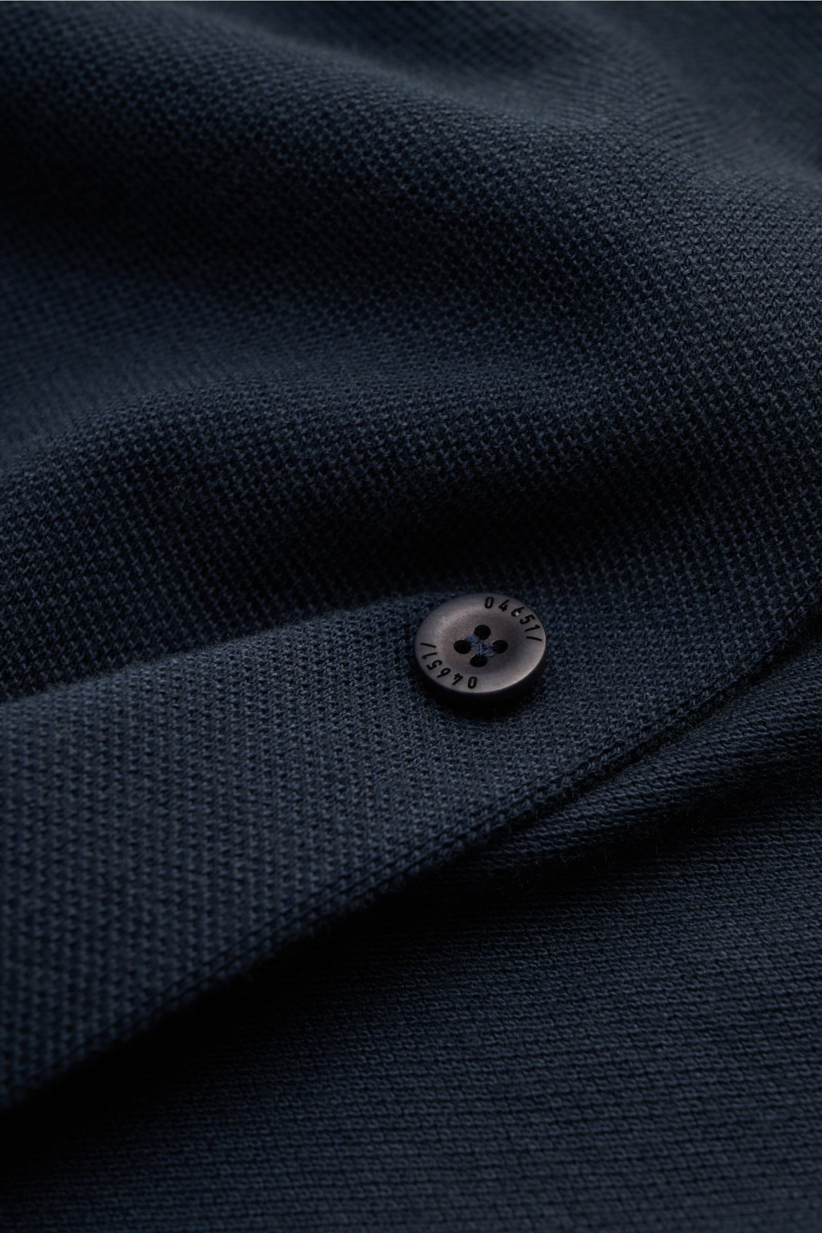 Close-up front view of navy textured fabric and black button with '04651' on 04651/ A trip in a bag Piqué shirt slim collar navy, casual everyday basic by 04651/ A TRIP IN A BAG: This casual shirt in pure cotton piqué has an attractive relaxed fit and can