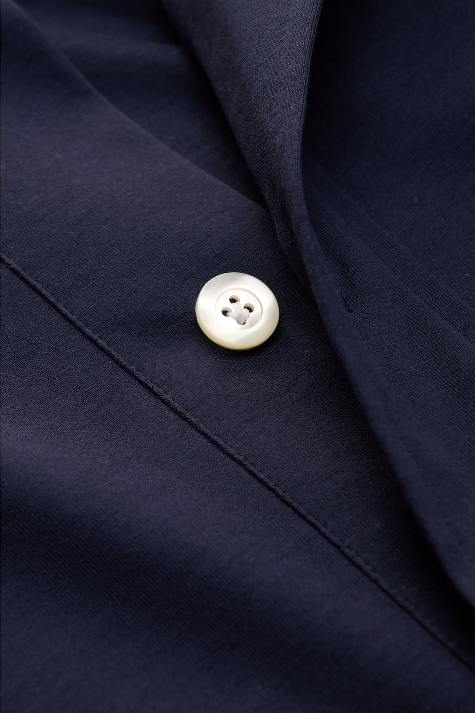 Nahaufnahme des Giampaolo Jersey Popover-Hemd Haifisch-Kragen navy in glattem, leichtem Baumwoll-Jersey mit Perlmuttknopf.