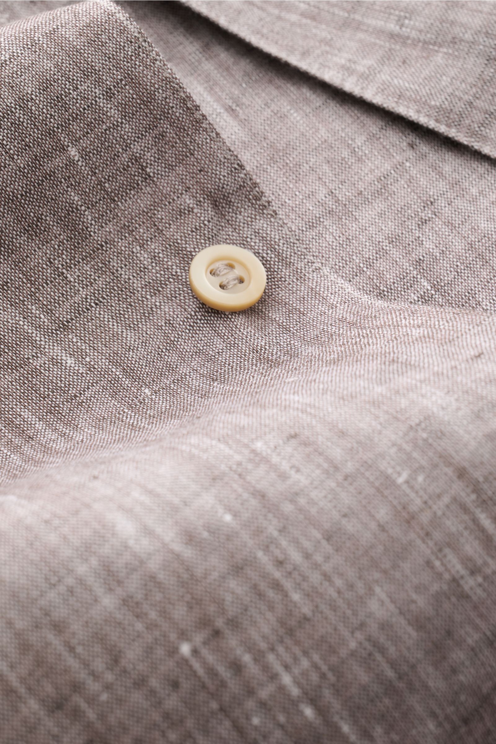 Alt tag (125 characters):
Close-up front view of Brunello Cucinelli Leinenhemd Haifisch-Kragen dunkelbraun meliert linen shirt with button detail.

Extended description:
Feinste Leinenqualität: Das sommerlich-leichte Hemd mit Haifischkragen aus dem Hau