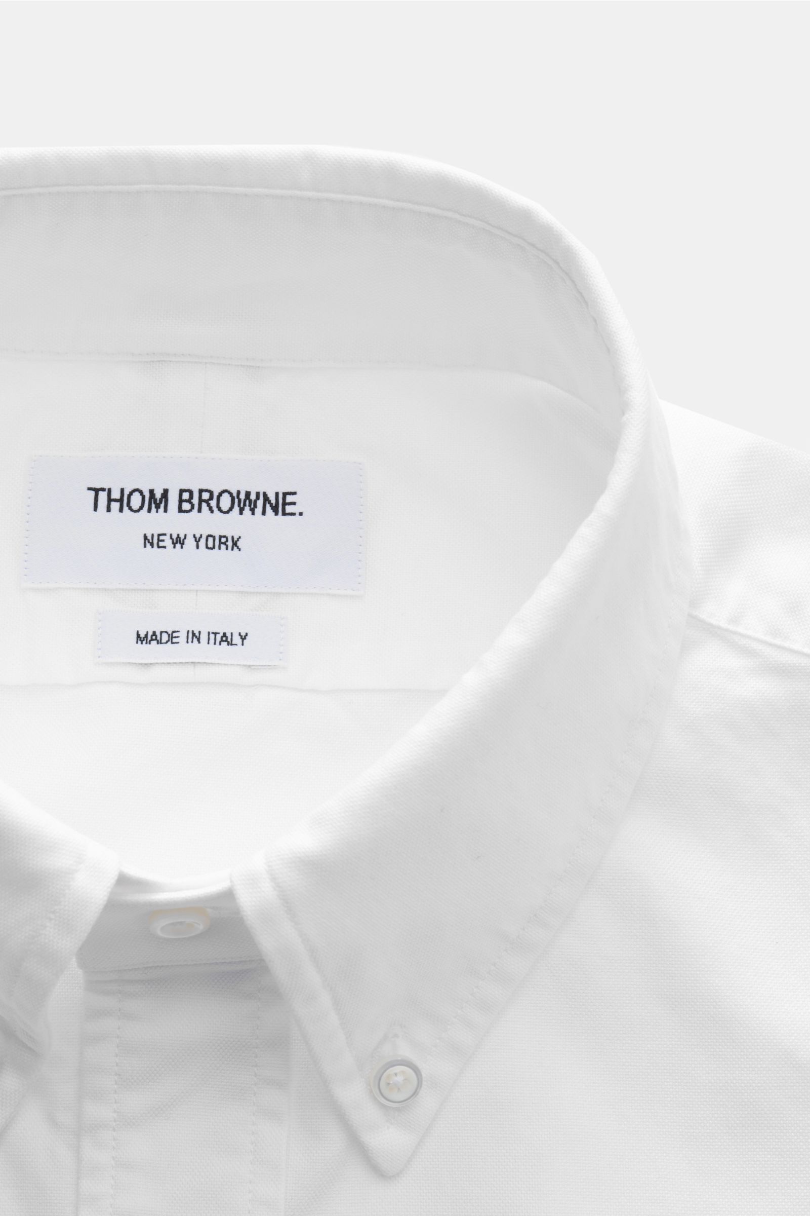 Close-up front view of Thom Browne Short-sleeve shirt button-down collar white, made of pure cotton Oxford fabric with a soft feel and regular fit.