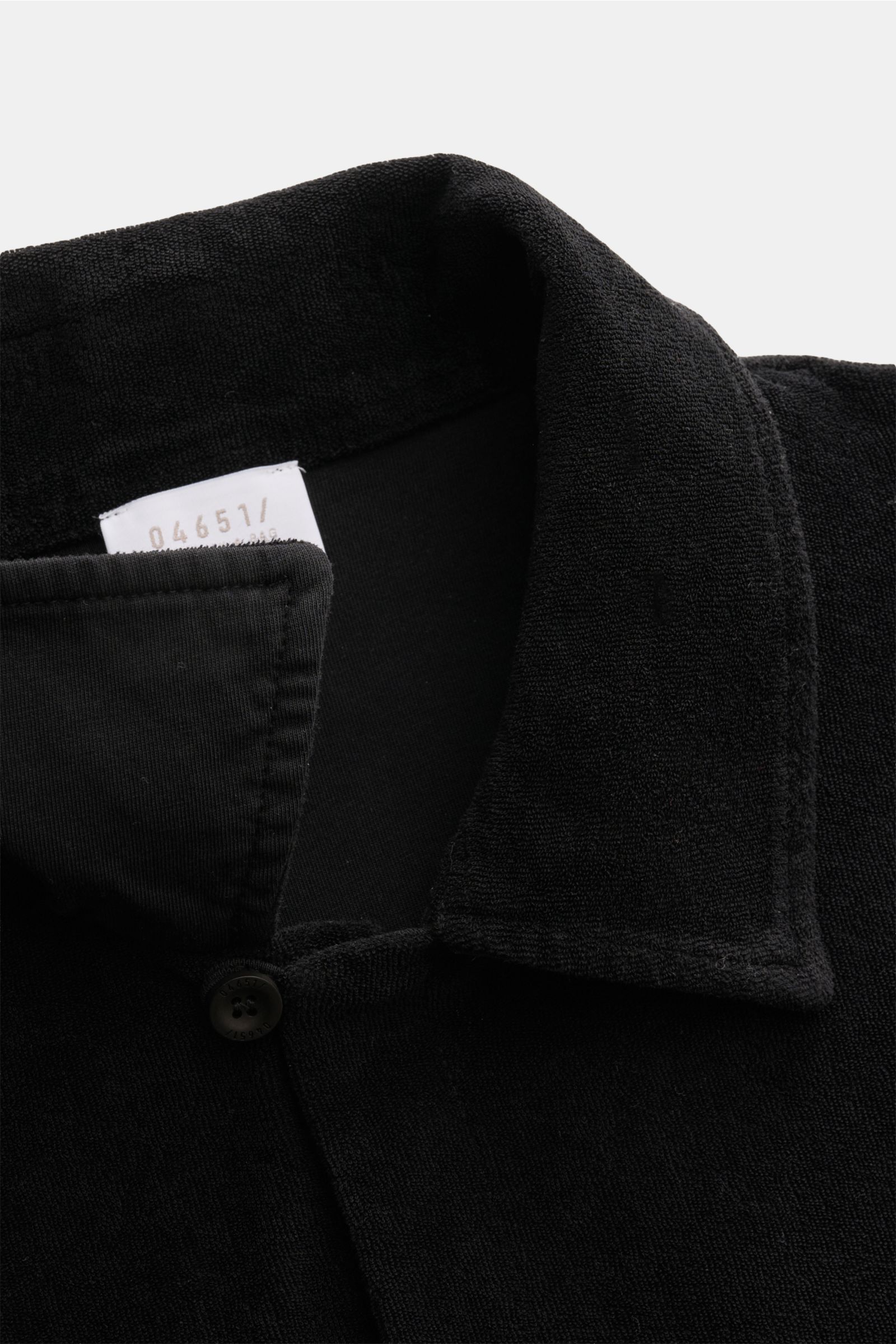 Close-up front-top view of 04651/ A trip in a bag Frottee-Kurzarmhemd 'Terry Cuba' schwarz with a soft cotton terry fabric, regular fit, variable Cuban collar, French button placket, small side seam label, and short hem slits, offering a casual, comfortab