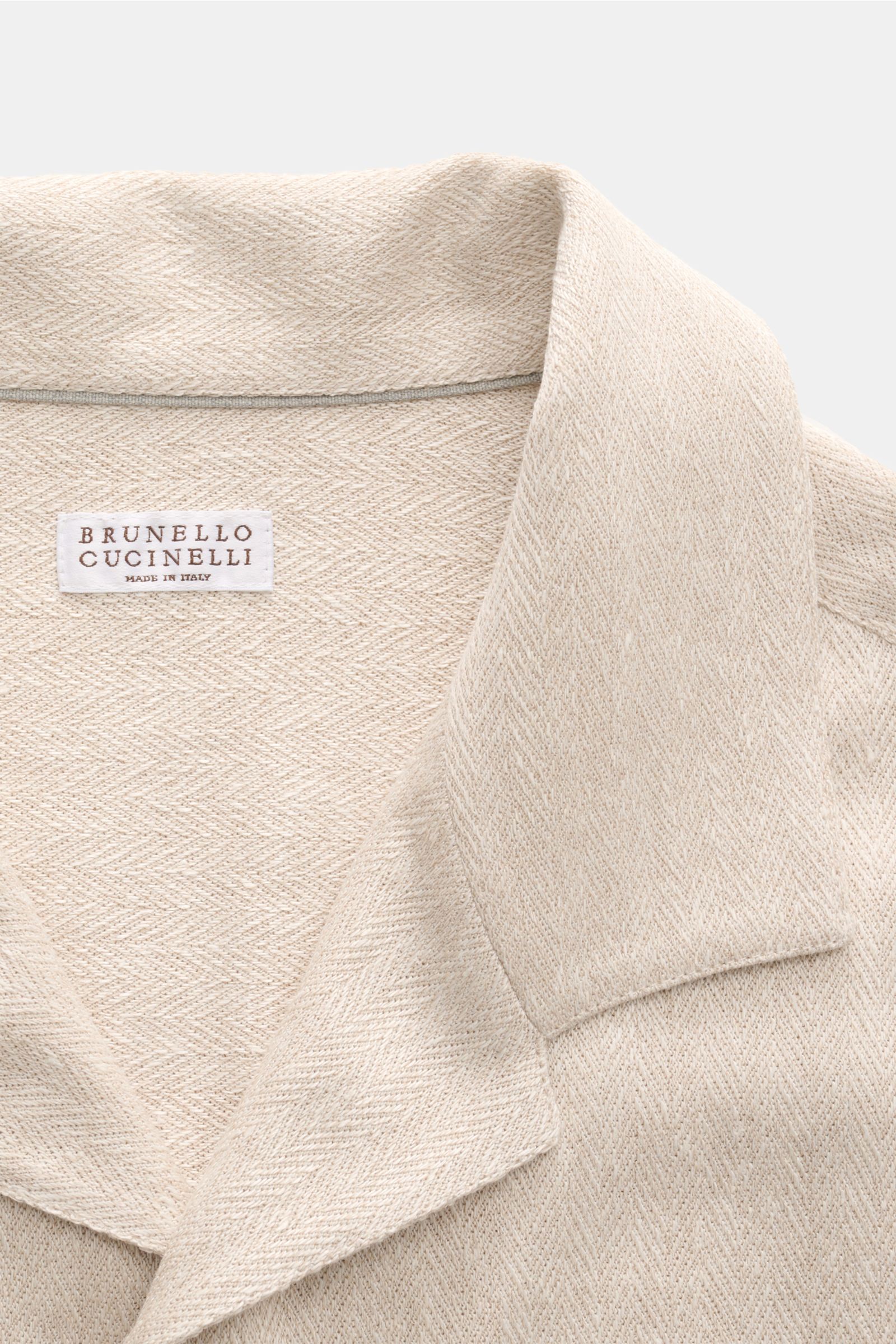 Brunello Cucinelli Kurzarm-Strickhemd beige meliert shown from close-up top-front angle, featuring linen-cotton mix, soft feel, fine fishbone knit, regular fit, smooth button placket, Cuban collar; elegant spring-summer luxury shirt with exceptional comfo