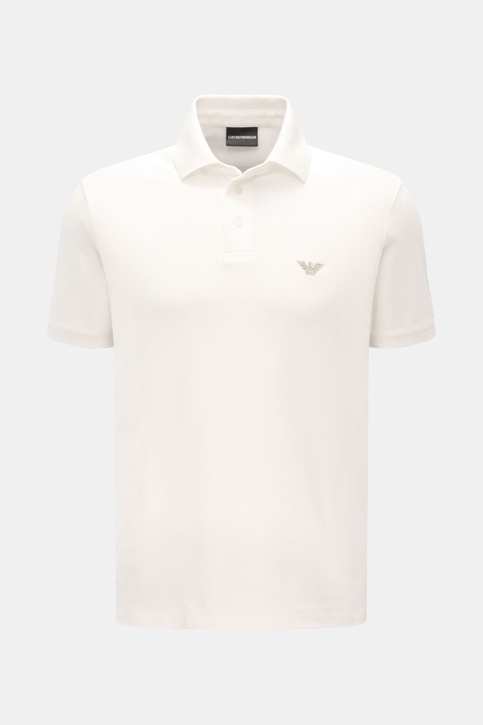 Emporio Armani Poloshirt offwhite shown from the front, featuring a classic polo collar, label stitching on chest, short sleeves, side hem slits, made from pure cotton piqué jersey with a slightly textured feel, regular fit. Vielseitiger Klassiker für spo