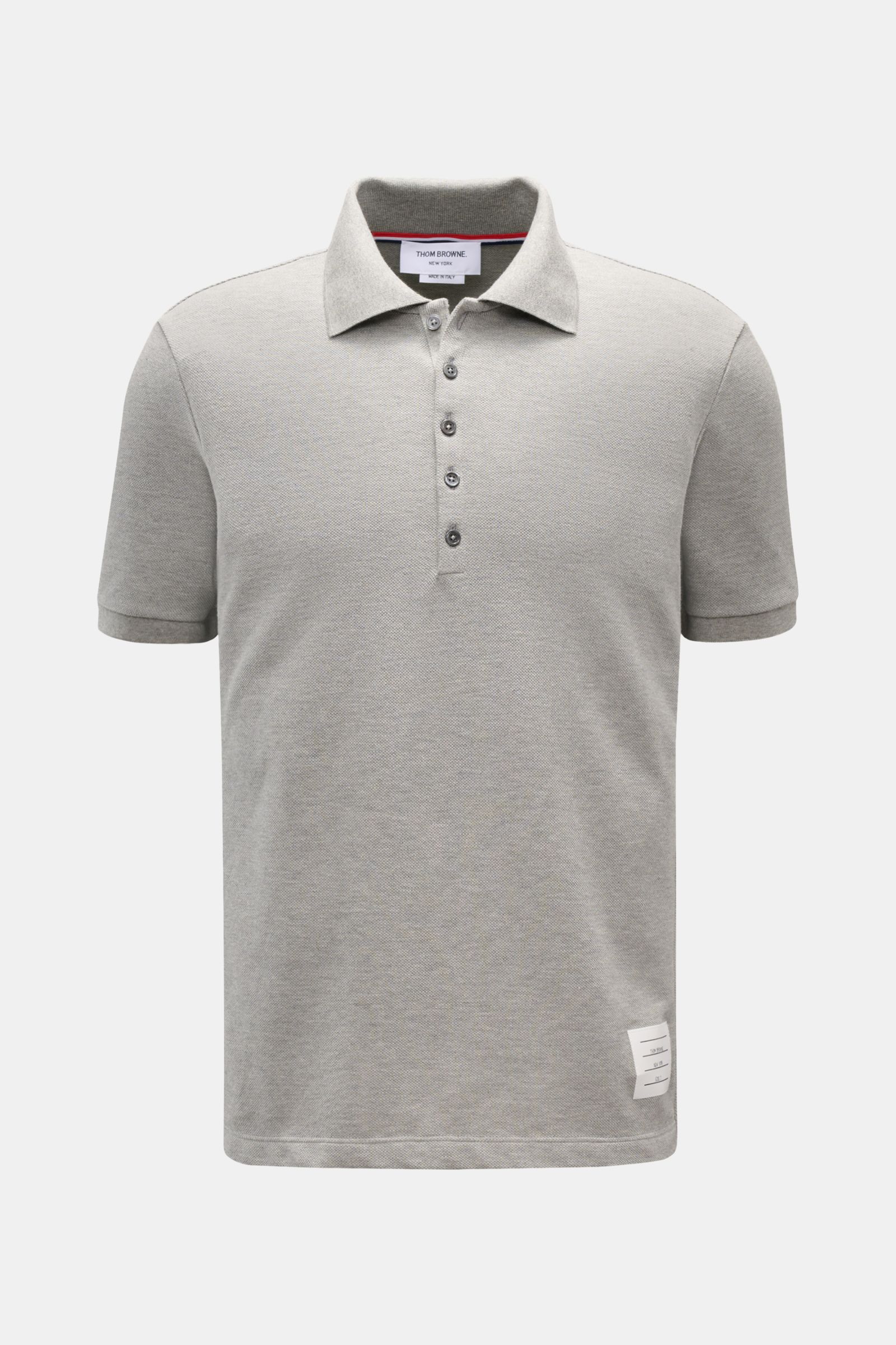 Front view of the Thom Browne Polo shirt grey mottled, a slim fit, pure cotton polo with a classic collar, five-button placket, ribbed cuffs, stretchy side inserts, and signature striped logo.

A modern essential: This polo shirt by THOM BROWNE is luxu