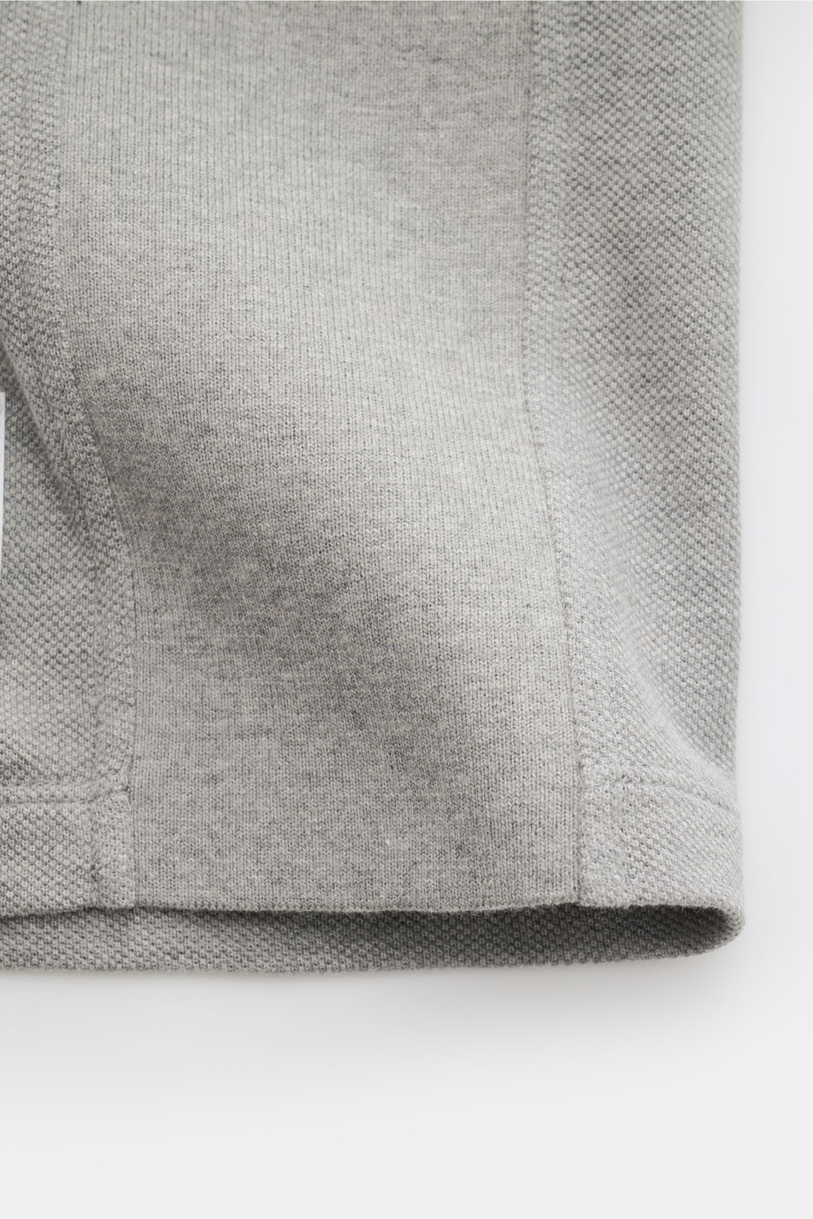 Close-up front view of the Thom Browne Polo shirt grey mottled showing lightweight pure cotton fabric with ribbed cuffs and stretchy side inserts.

A modern essential: This polo shirt by THOM BROWNE is luxurious and comfortable, which makes it a sporty