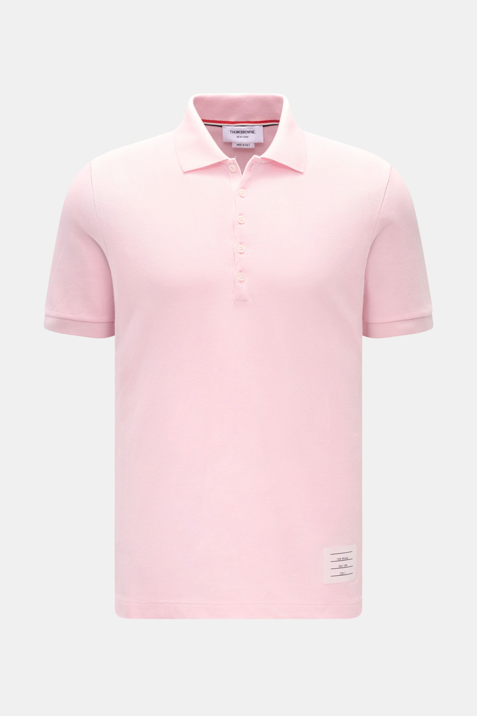 Front view of Thom Browne Poloshirt rosé in slim fit, made of pure cotton with a classic collar, five-button placket, ribbed cuffs, elastic side inserts, and signature stripe logo, showcasing a modern essential with luxurious comfort.