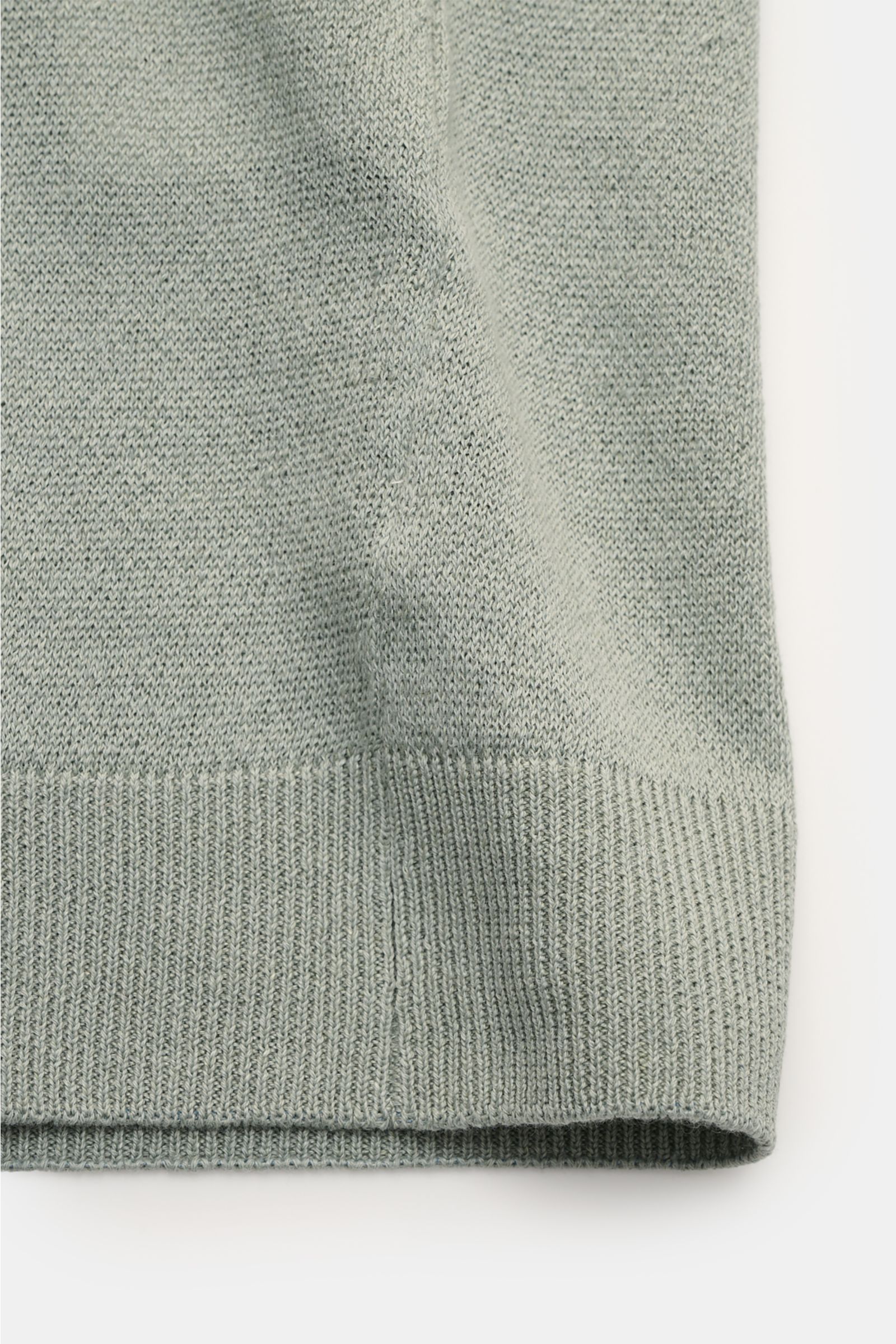 Lardini Short sleeve knit polo sage shown from a close-up side perspective, highlighting the fine, airy linen and cotton blend knit, ribbed hem, and lightweight texture. Elegance for the warmer seasons from LARDINI: This short-sleeved knit polo made from 
