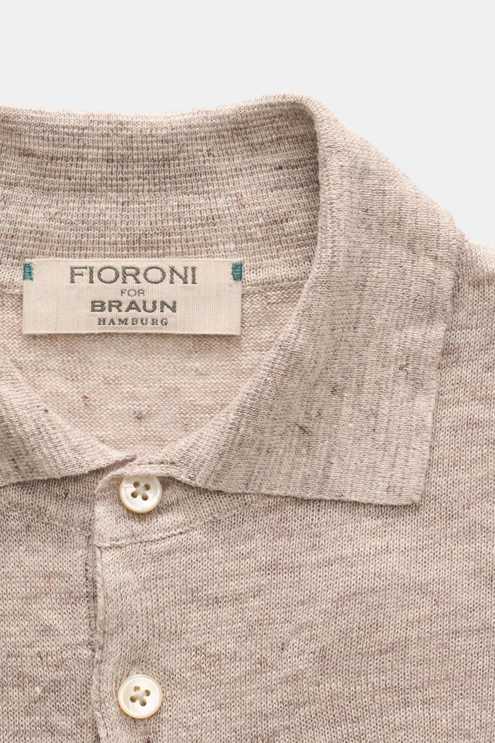 Close-up front view of Fioroni Linen short sleeve knit polo beige/brown mottled with dress-shirt collar and two buttons visible.

Summery lightness by FIORINI: This short sleeve knit polo embodies the best Italian quality and is made of pure linen to k