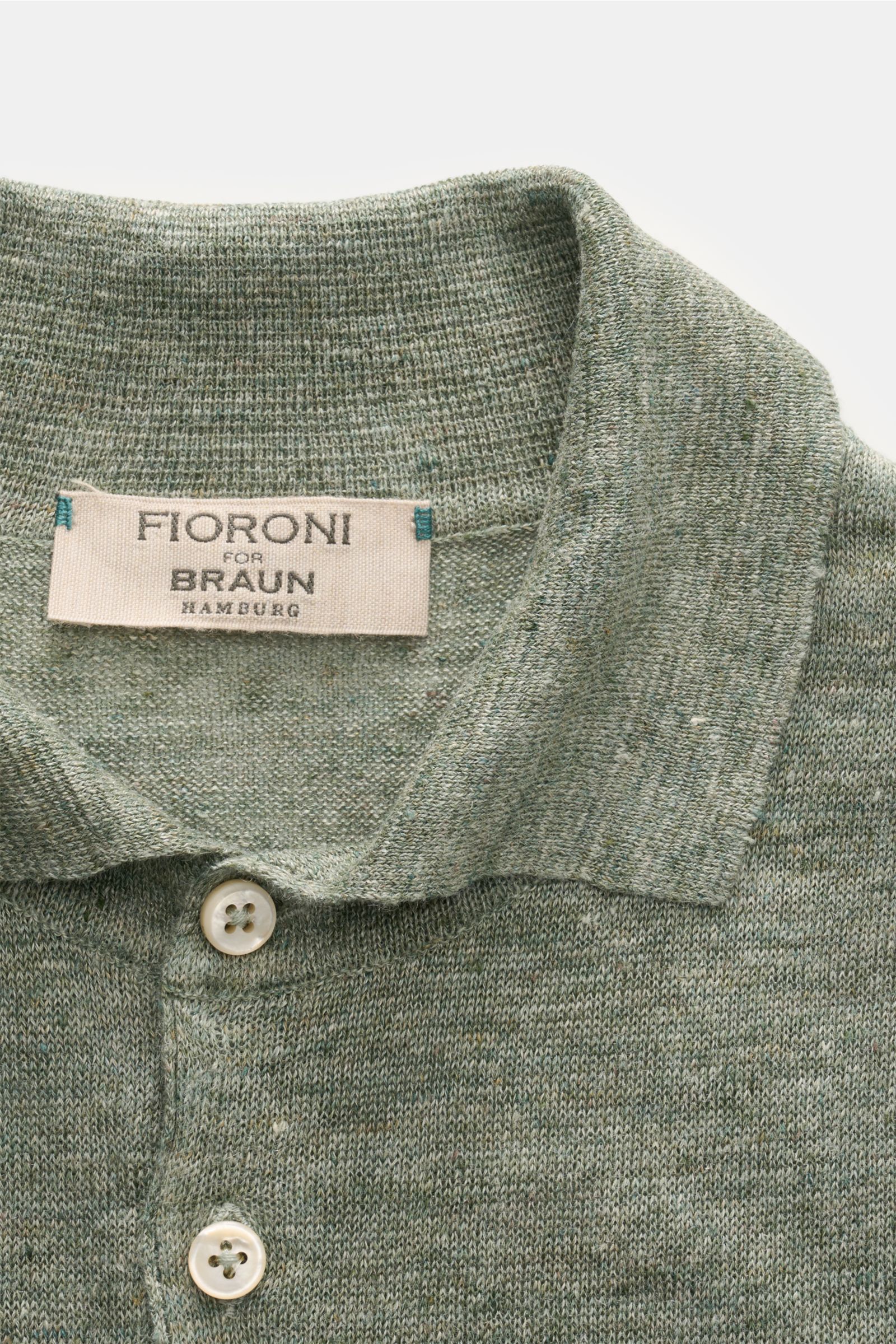Close-up front view of Fioroni Linen short sleeve knit polo dark green/beige mottled, showing dress-shirt collar and three-button placket.

Description: Summery lightness by FIORINI: This short sleeve knit polo embodies the best Italian quality and is 