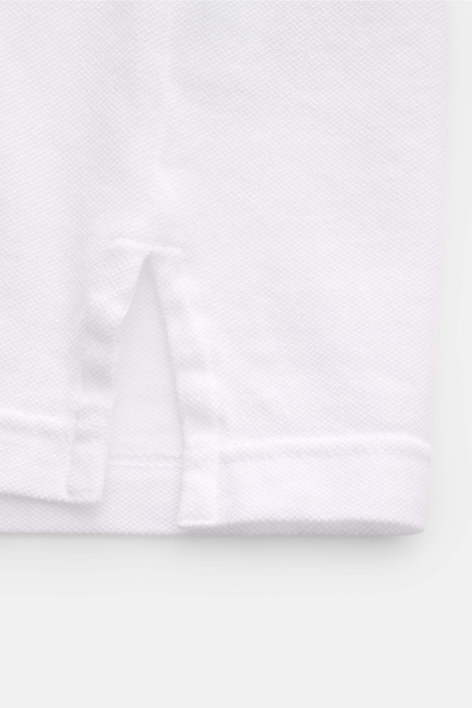 Fedeli Poloshirt 'North' weiß im Slim Fit, Detailansicht Saum mit seitlichem Schlitz aus hochwertigem, garment dyed Baumwoll-Piqué.