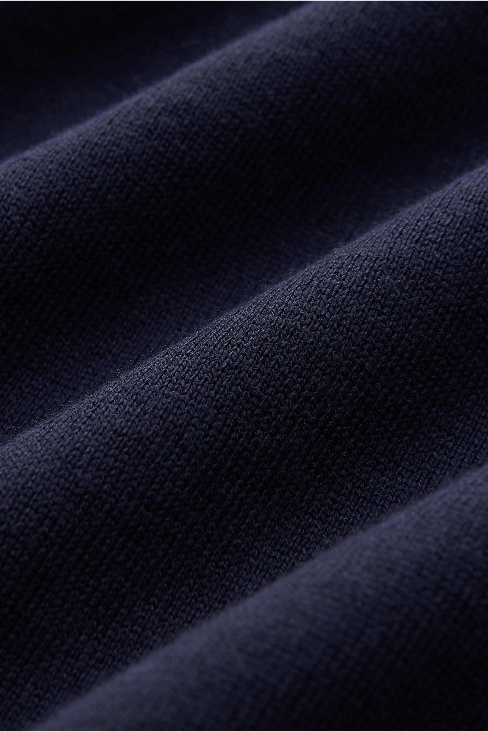 Alt tag (124 characters):
Close-up texture detail of navy fine knit fabric showing soft, supple cotton of Brunello Cucinelli short sleeve knit polo shirt navy.

Description:
This timeless short-sleeved polo shirt from BRUNELLO CUCINELLI features a ligh
