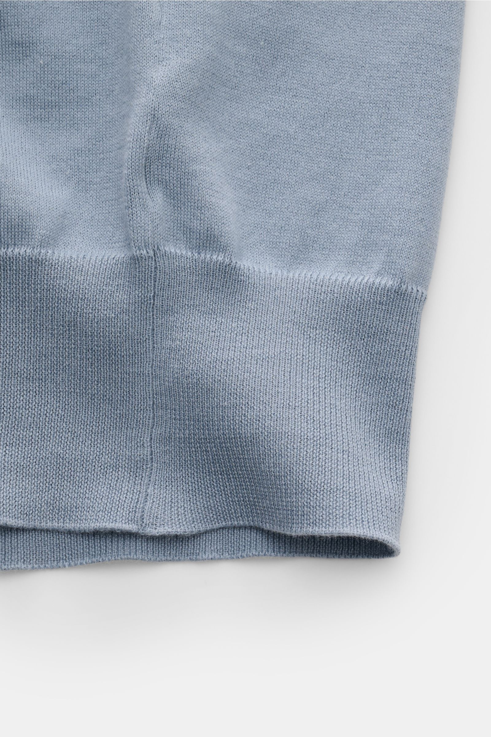 Close-up of the hem and side seam of the Brunello Cucinelli Kurzarm-Strickpolo rauchblau, photographed from the side showing its fine cotton knit.

Description: Luxuriöse Alltags-Looks profitieren von der leichten Strickqualität dieses zeitlosen Kurzar