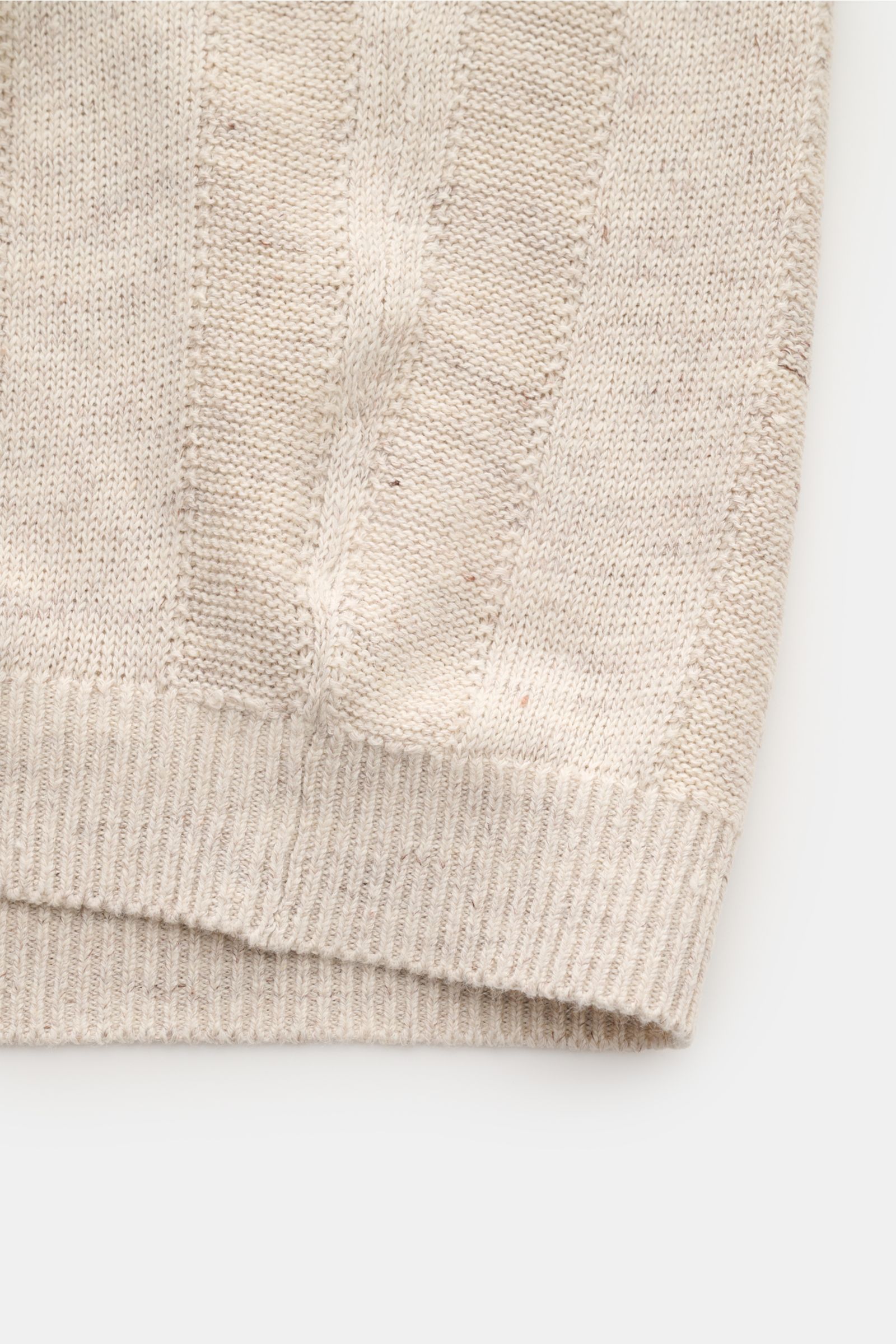 Close-up view of the lower front edge of the Brunello Cucinelli Kurzarm-Strickhemd sand meliert, showing its soft linen-cotton knit with striped pattern, narrow contrast edges, and ribbed hem. Elegantes Highlight in der Frühlings- und Sommersaison: Das