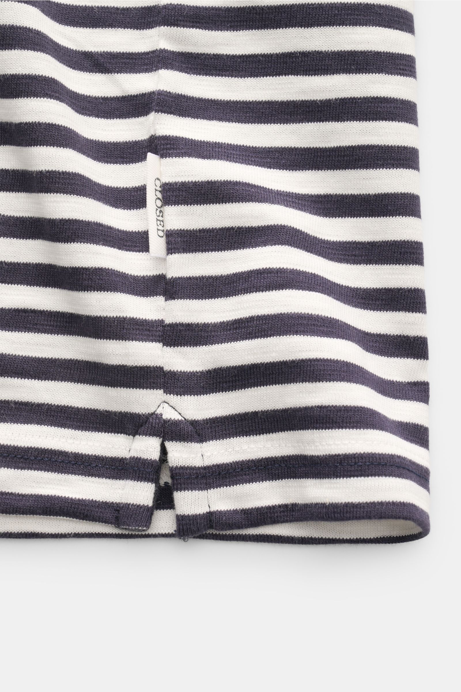 Close-up front view of the hem and side vent of the Closed Short sleeve knit polo dark navy/cream striped, showing fine knit cotton fabric with soft feel and slim fit.

This CLOSED short sleeve knit polo is made from pure, soft cotton and is a sporty e