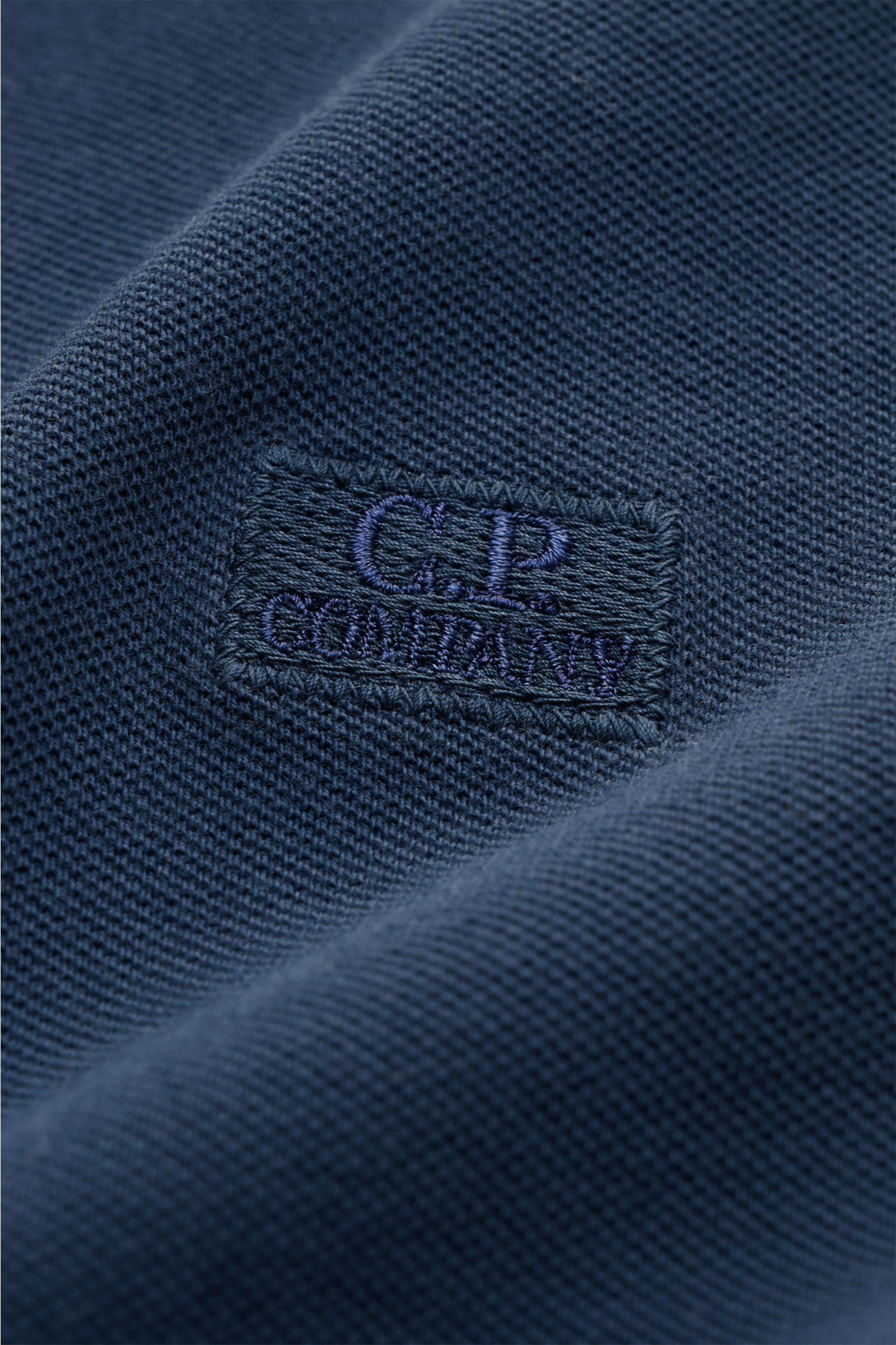 C.P. Company Poloshirt dunkelblau, Detailaufnahme des Weblabels auf weichem, atmungsaktivem Baumwoll-Piqué mit Slim Fit und klassischem Polokragen.