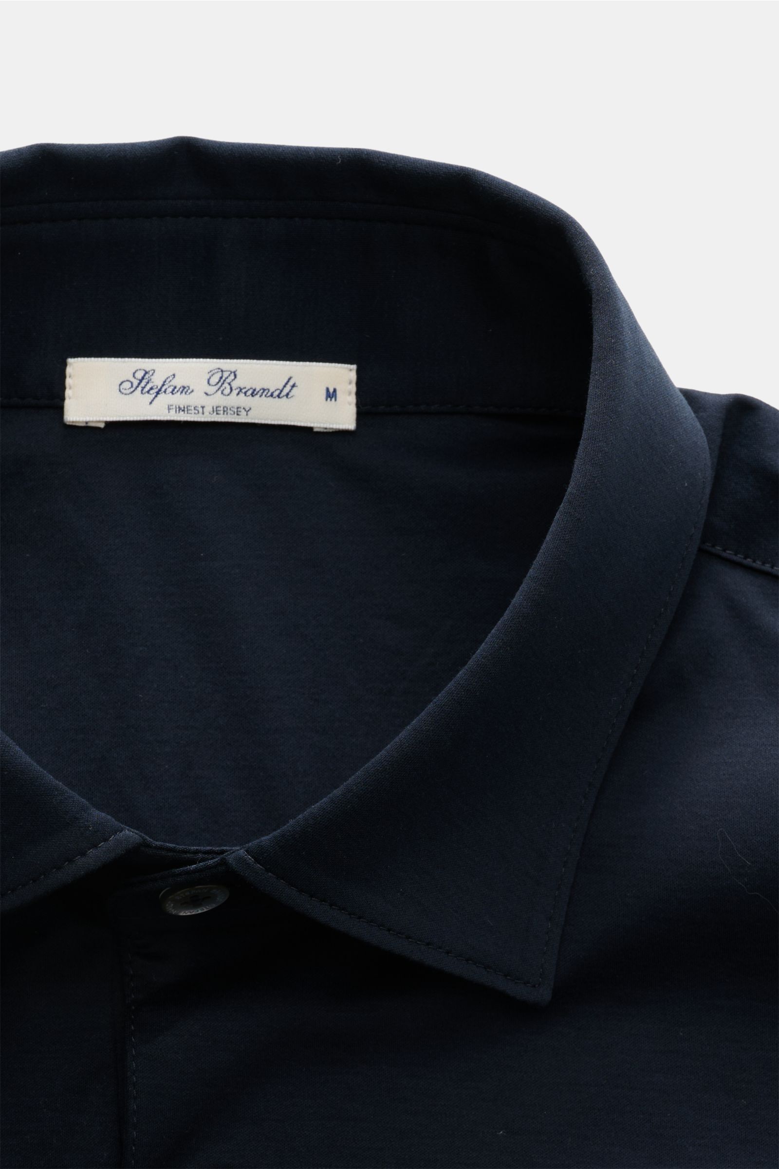 Close-up front view of the collar and label of the Stefan Brandt Jersey-Poloshirt 'Luca' dark navy. Feinster Komfort für jeden Tag: Das exklusive Jersey-Poloshirt 'Luca' von 