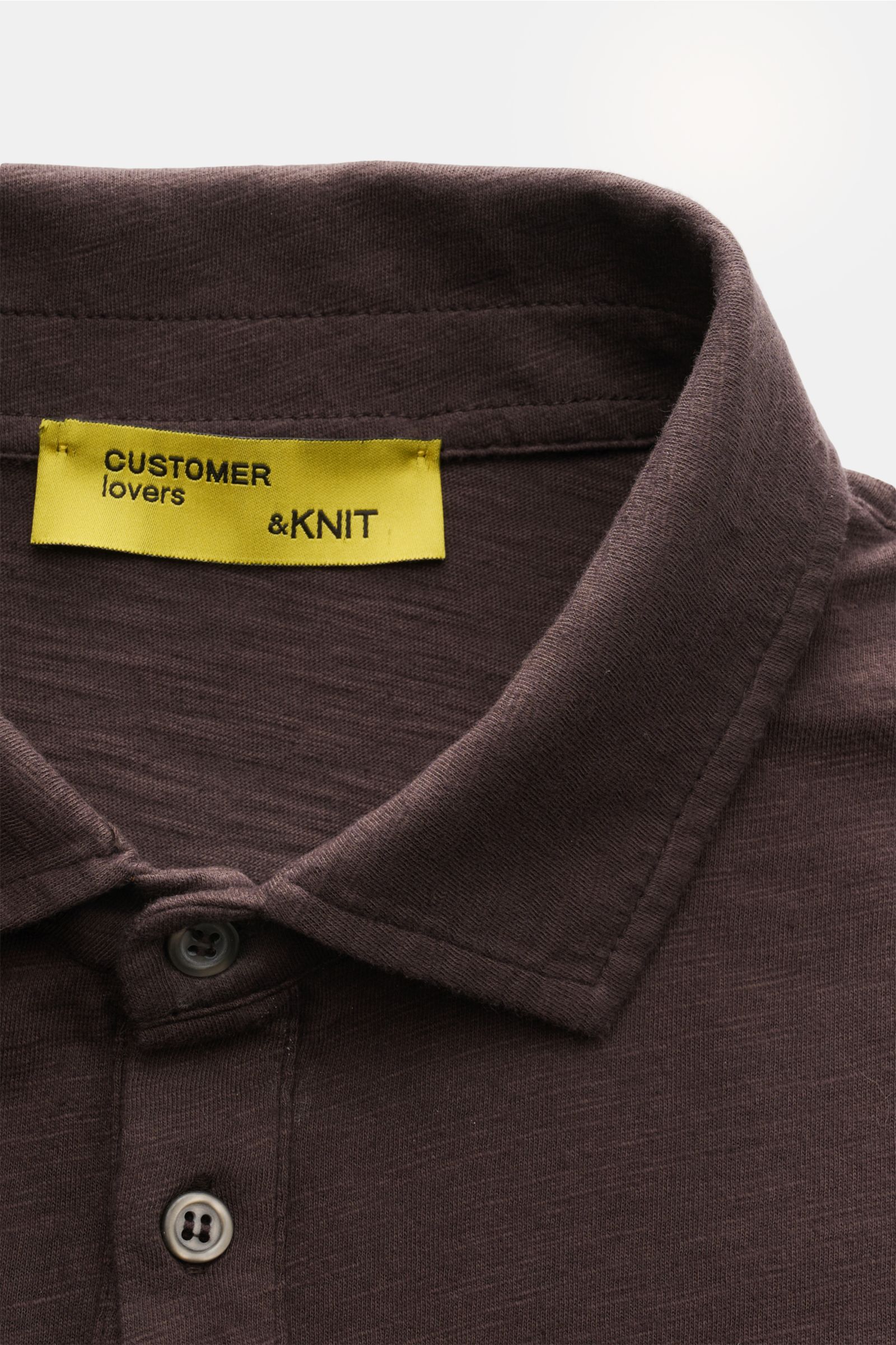 Close-up front view of the B.F. Knitwear Jersey polo shirt dark brown showing its classic polo shirt collar and buttons. Uncomplicated classic: This jersey polo shirt by B.F. KNITWEAR is a versatile basic for the warmer months.

Pure cotton