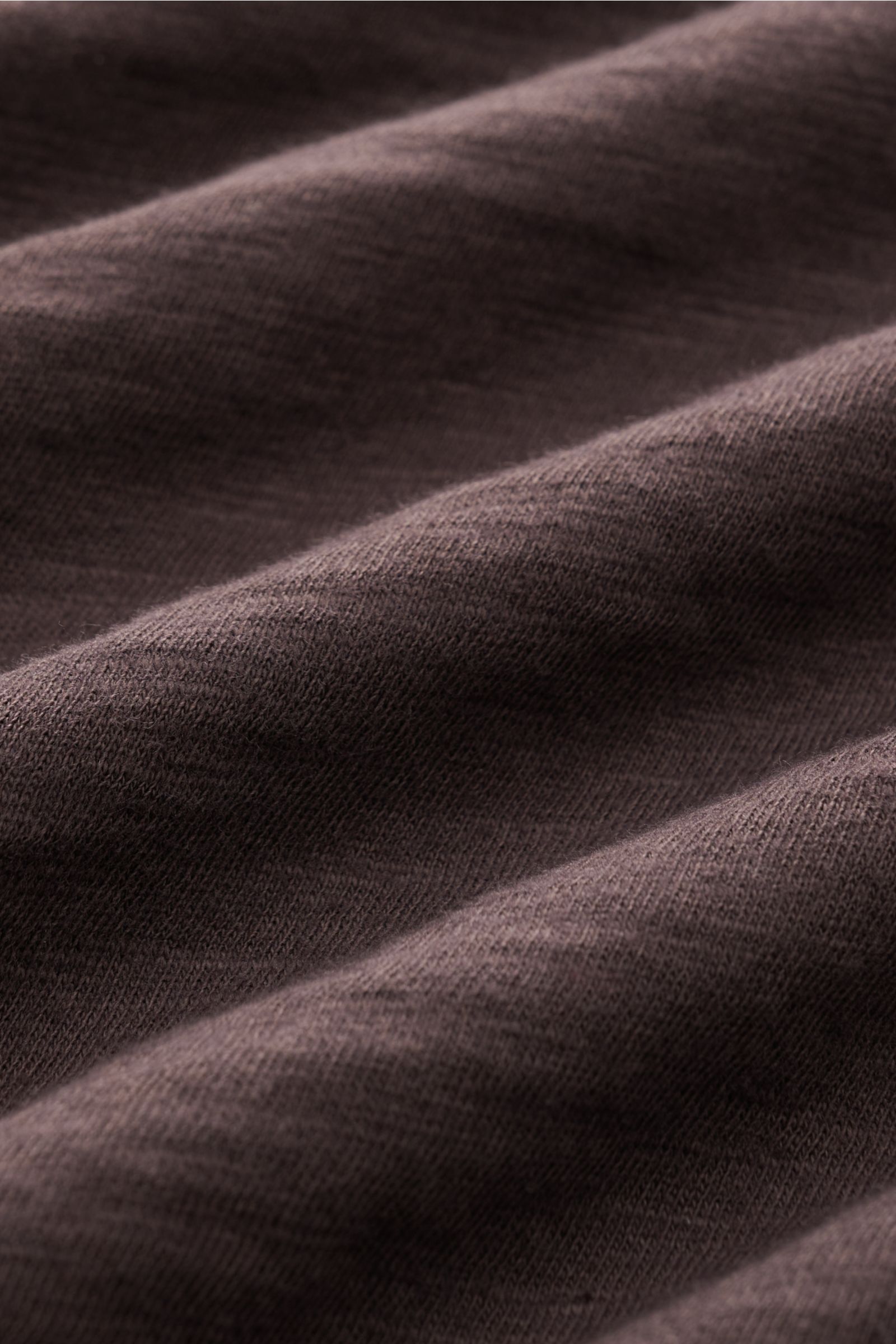 Close-up front view of dark brown pure cotton fabric texture of the B.F. Knitwear Jersey polo shirt dark brown with a soft feel and classic polo collar. Uncomplicated classic: This jersey polo shirt by B.F. KNITWEAR is a versatile basic for the warmer mon