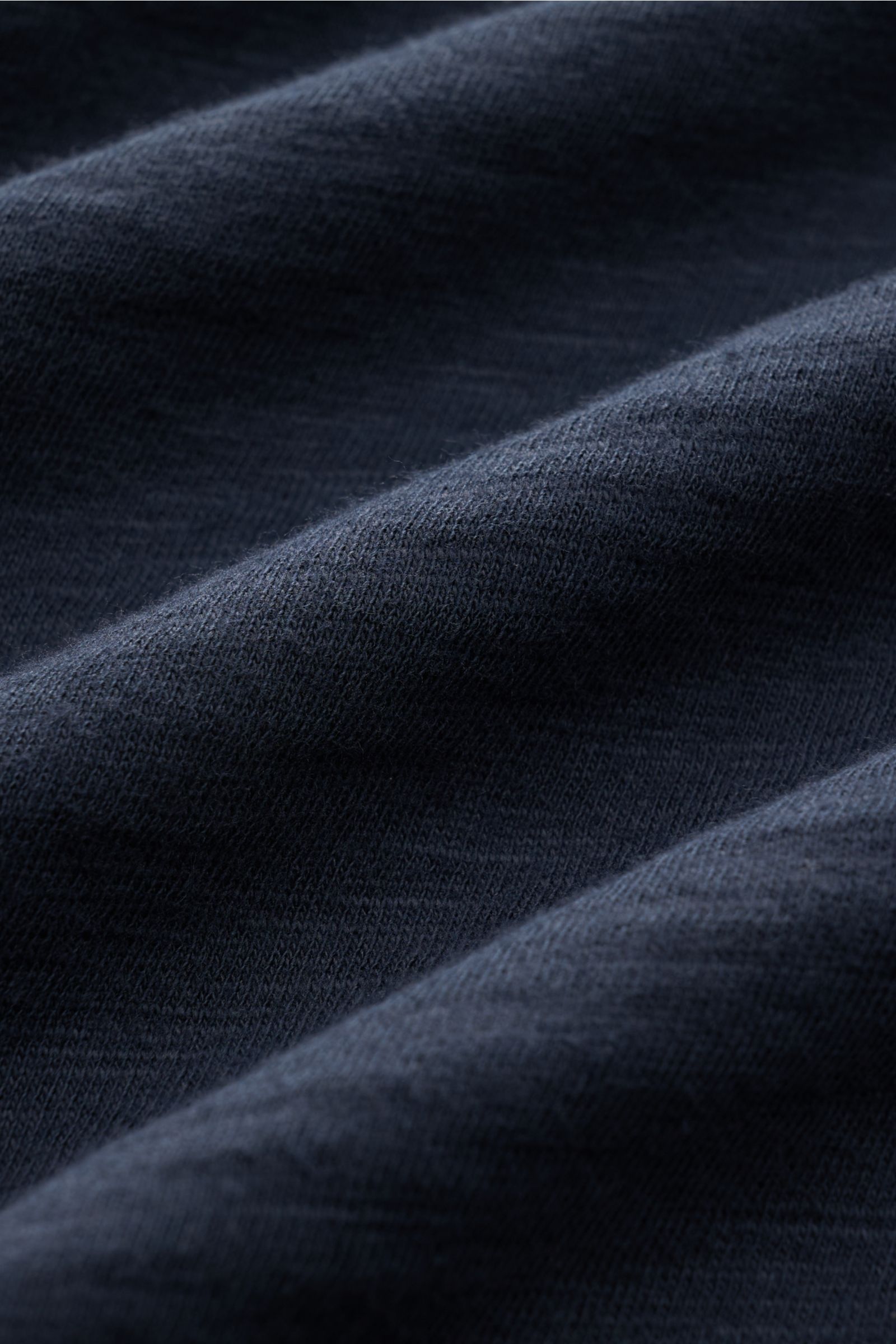 Close-up front view of the textured fabric of the B.F. Knitwear Jersey polo shirt navy, showing pure cotton, soft feel, slim fit, and classic polo collar. Uncomplicated classic: This jersey polo shirt by B.F. KNITWEAR is a versatile basic for the warmer m