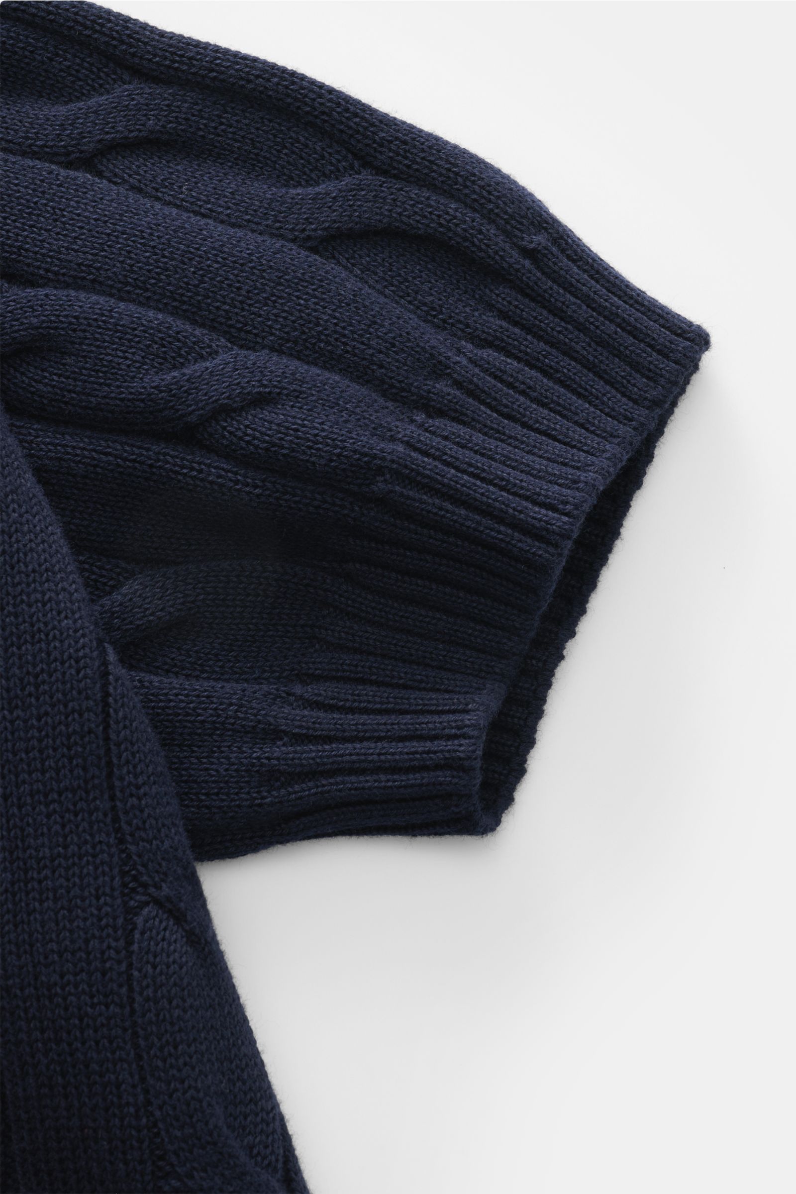 Close-up of navy cable knit sleeve cuff of Gran Sasso Short sleeve knit polo shirt navy, photographed from above, showing ribbed bands and soft cotton fabric. Perfect for hot days: This short sleeve knit polo by GRAN SASSO in an exclusive design for BRAUN