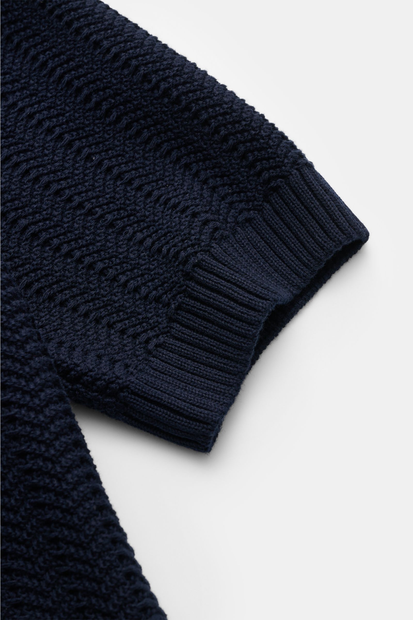 Close-up side view of Gran Sasso Short sleeve knit polo shirt navy showing textured, heavy knit cotton fabric with wide ribbed bands on sleeve cuff, classic collar, and slim fit design. Classic polo silhouette meets a distinctive fabric thickness: This sh