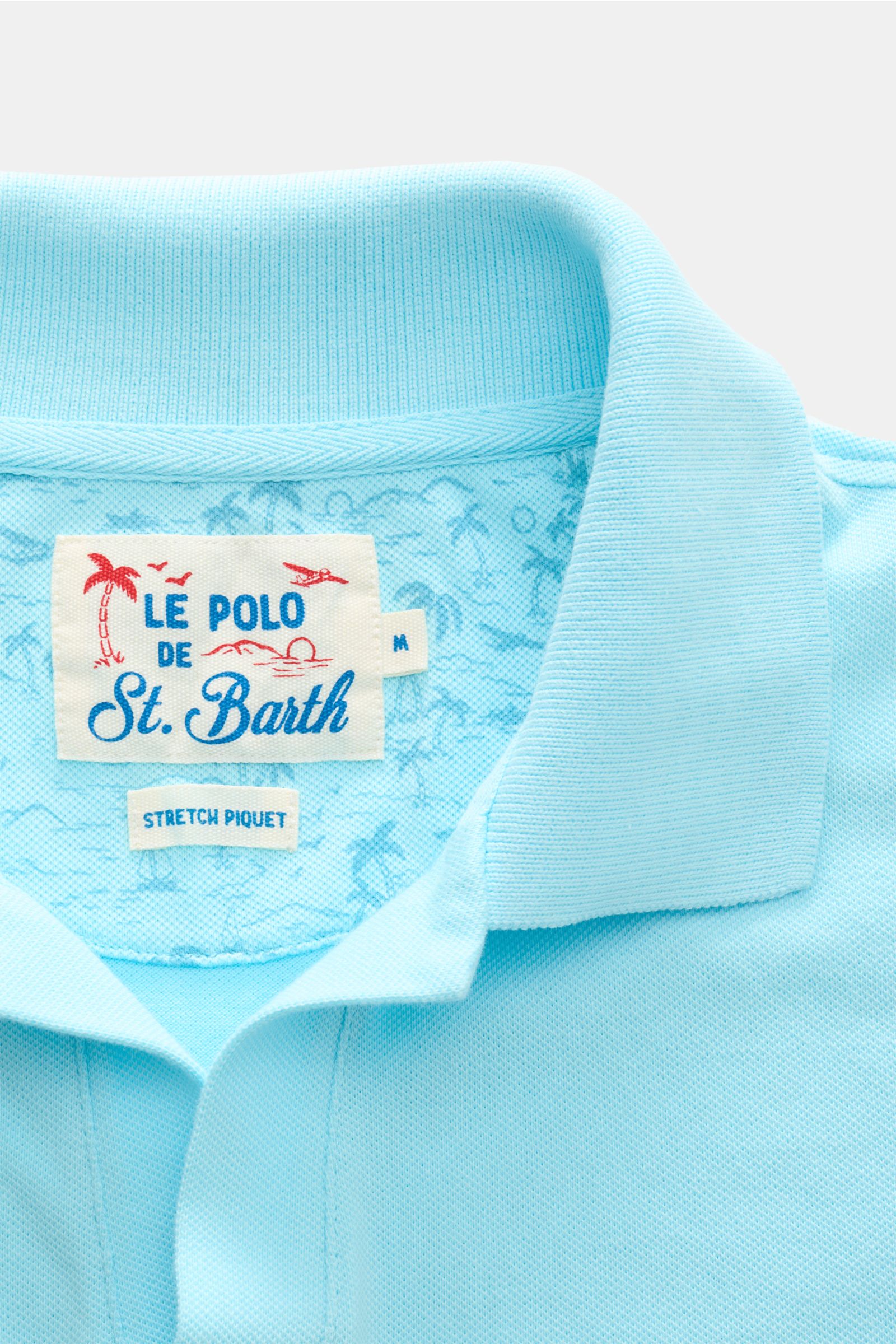 Close-up front view of the MC2 Saint Barth Poloshirt 'Charles' türkis collar and label, showing turquoise stretch cotton piqué fabric with soft texture.