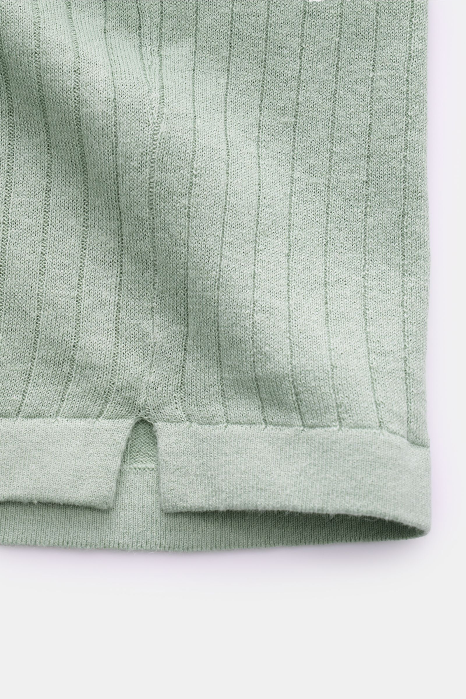 MC2 Saint Barth Short sleeve knit polo mint green shown in close-up from the front hem, highlighting fine knit linen-cotton blend, slim fit, ribbed bands, open collar strip, and short hem vents. 