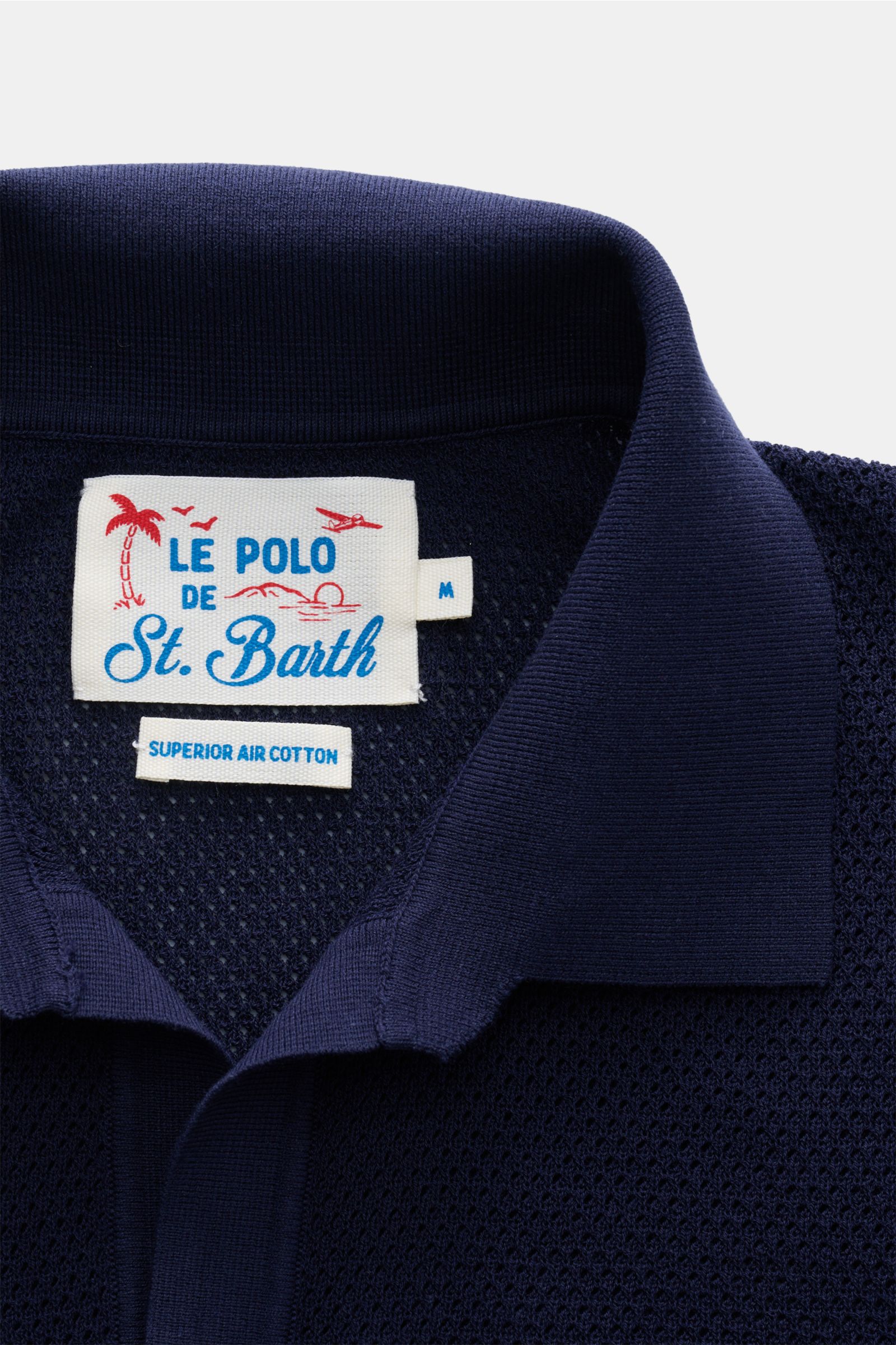 Close-up front view of the navy MC2 Saint Barth Short sleeve knit polo 'Sloan' showing the collar and label with fine textured pure cotton knit.

Light and summery: This knit polo shirt by 