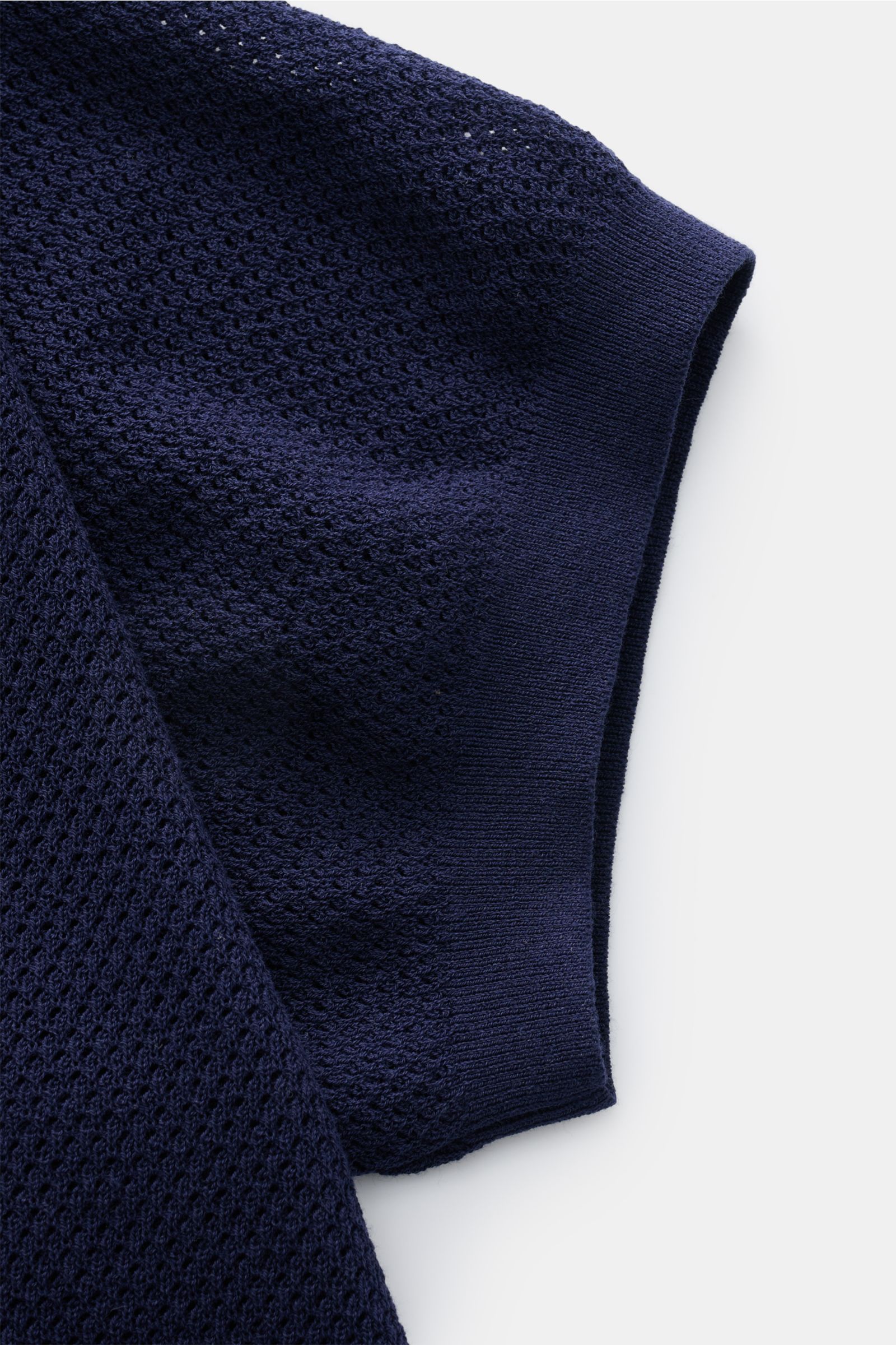 Close-up view of the navy sleeve of the MC2 Saint Barth Short sleeve knit polo 'Sloan', showing fine textured, slightly granular pure cotton knit fabric.

Description: Light and summery: This knit polo shirt by 