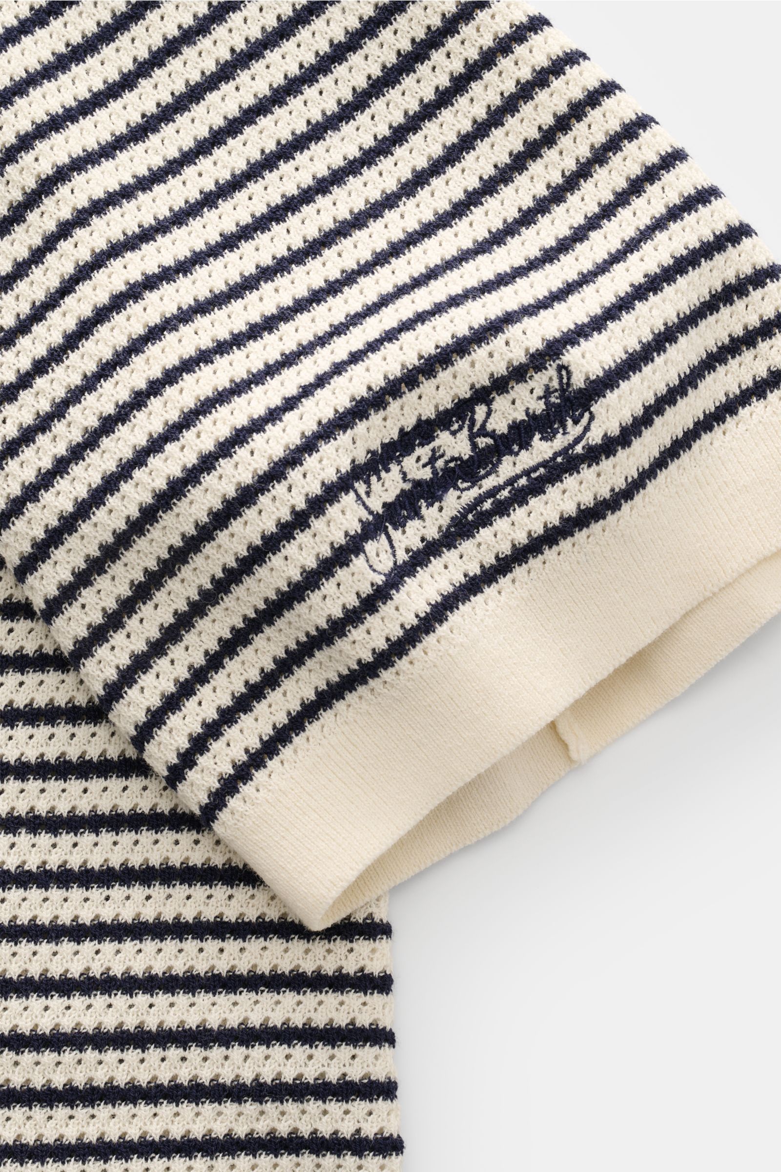 Alt tag (125 characters max): Close-up angled view of MC2 Saint Barth Short sleeve knit polo 'Sloan' cream/navy striped with fine textured knit and logo stitch.

Additional description: Light and summery: This knit polo shirt by 