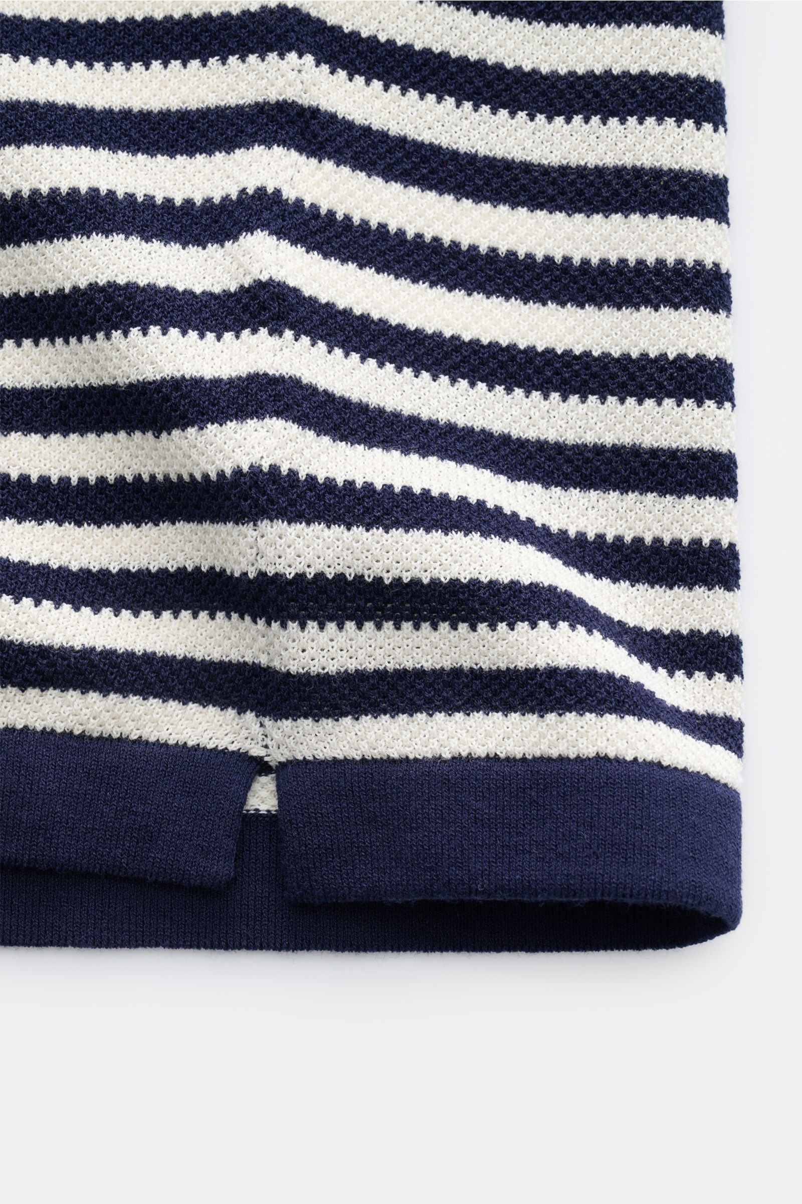 Close-up of the hem detail of the MC2 Saint Barth Short sleeve knit polo 'Sloan' navy/cream striped, showing fine textured knit and short hem vents.

Description: Light and summery: This knit polo shirt by 