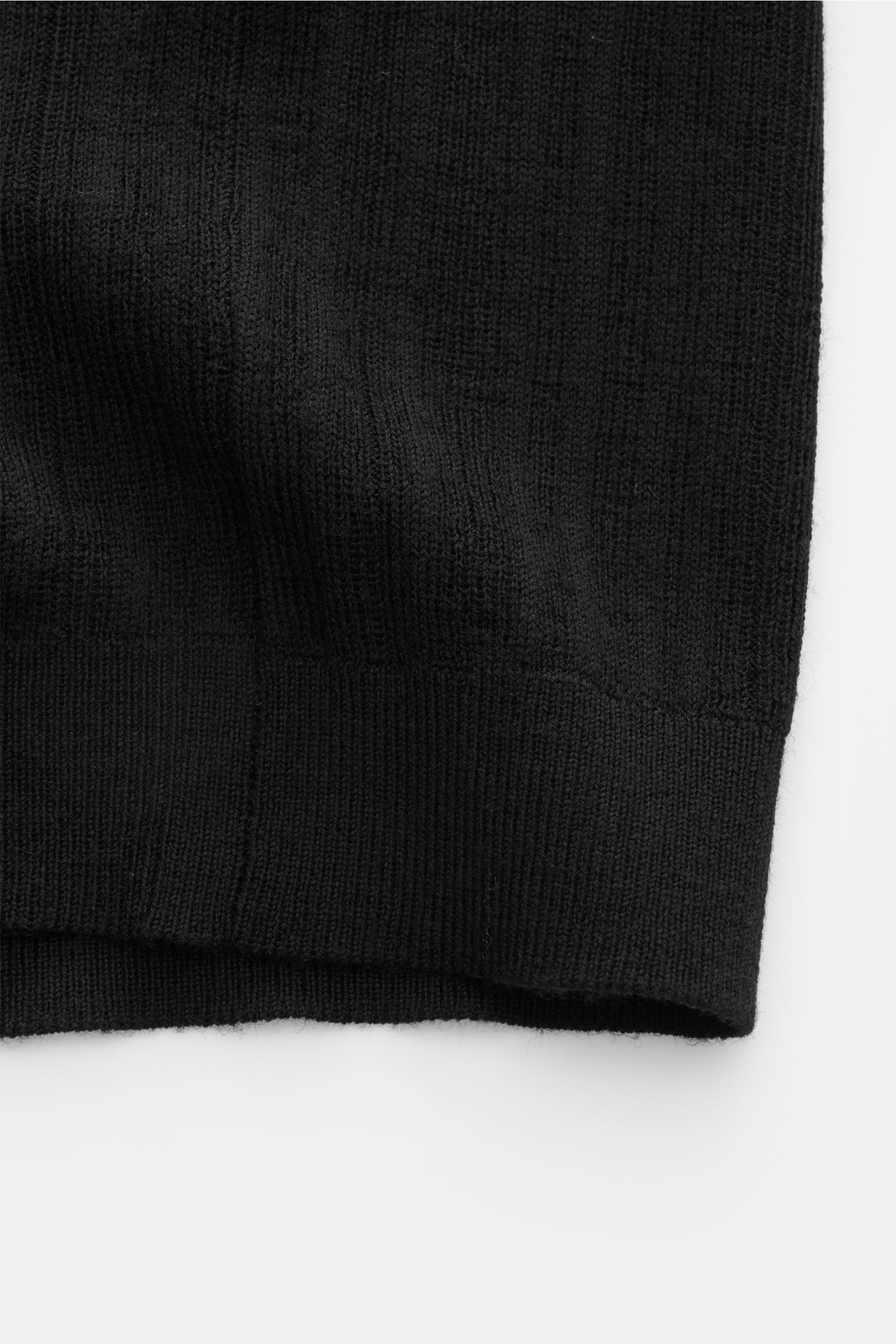 Close-up view of the fine textured knit fabric and narrow ribbed bands of the Kiefermann Merino short sleeve knit polo 'Bortiso' black, photographed from the side.

Description:  
An elegant styling piece: For a holiday dinner or a walk on the promenad