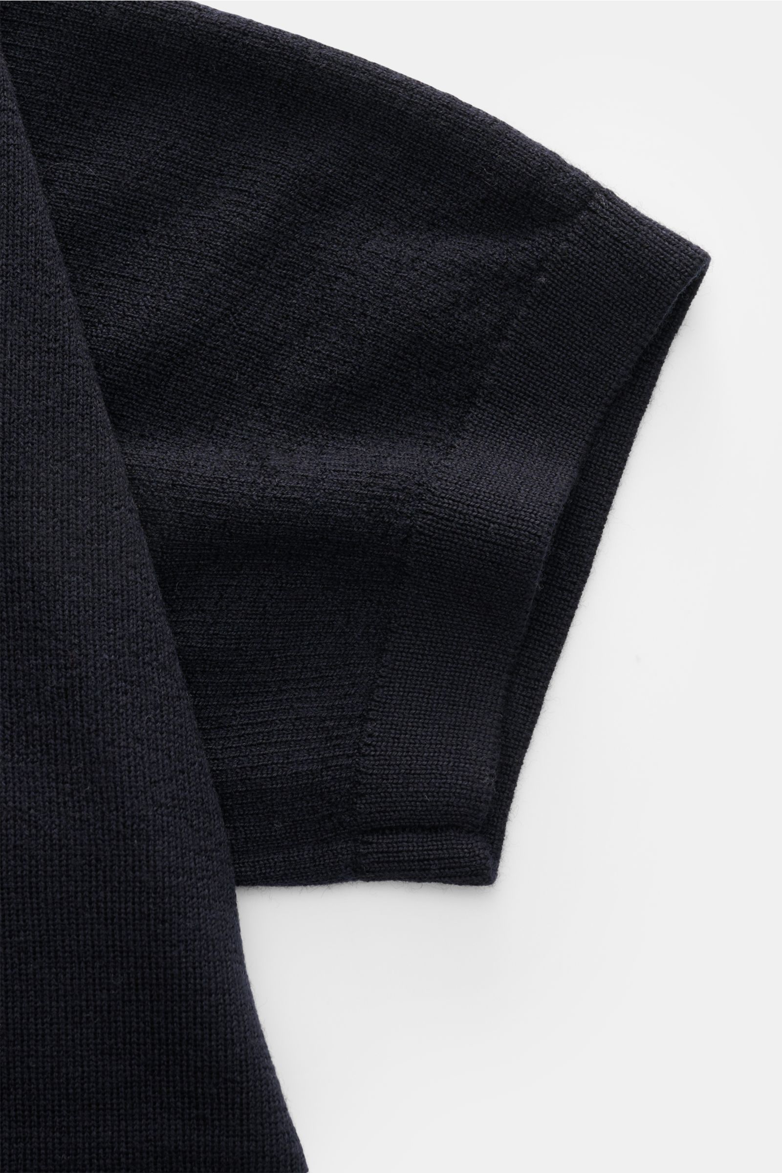 Close-up top-down view of the short sleeve on the Kiefermann Merino short sleeve knit polo 'Luras' dark navy, showcasing fine merino wool knit texture, rib knit cuff, and soft feel. Sporty and timeless: This short sleeve knit polo by KIEFERMANN in high-qu