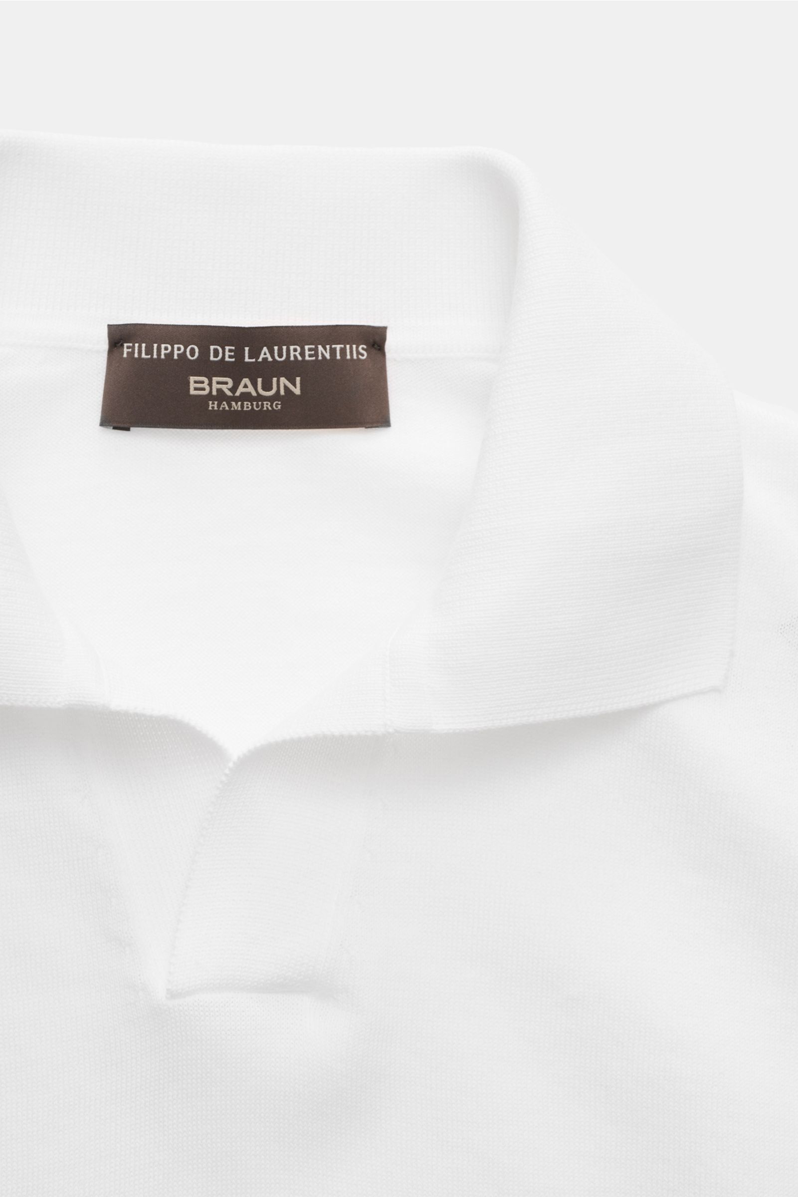Close-up front view of Filippo de Laurentiis Short sleeve knit polo shirt white, featuring fine pure cotton knit, slim fit, signature polo collar with open placket, and ribbed bands. Summery elegance at its most relaxed: This short sleeve knit polo by 