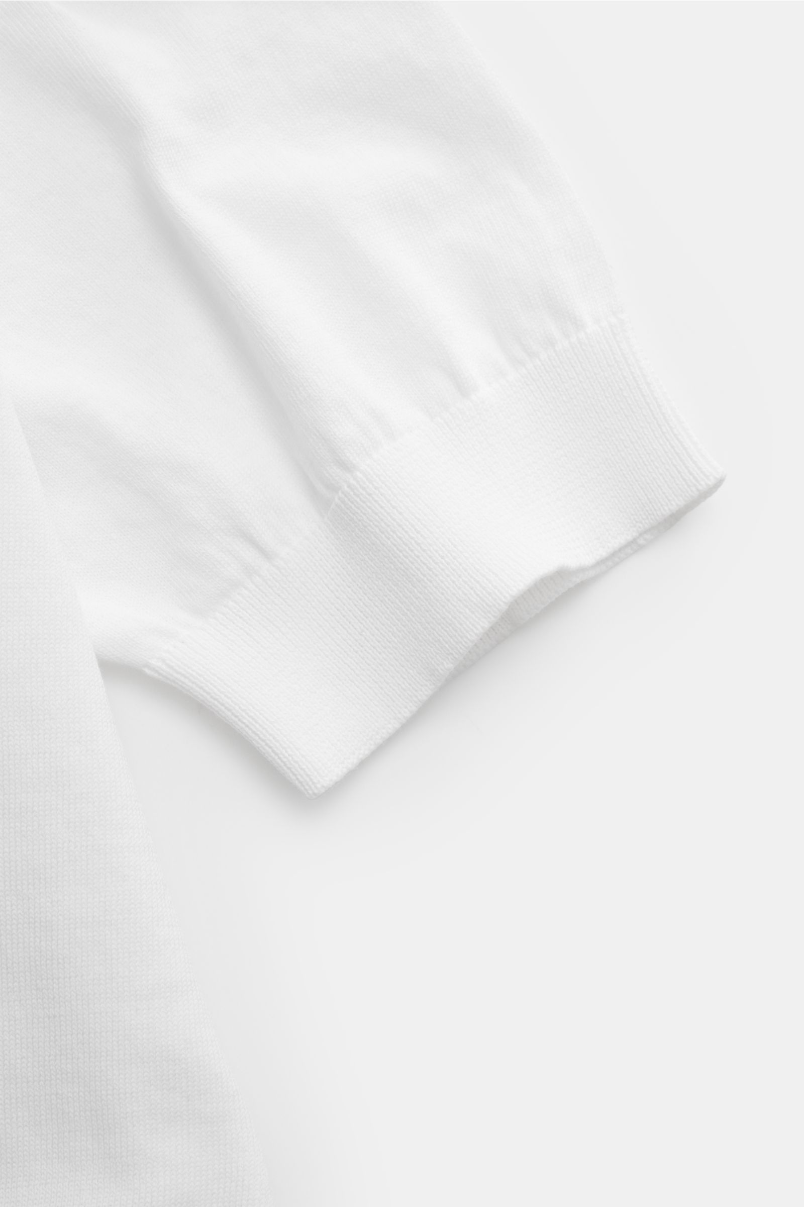 Close-up view of Filippo de Laurentiis Short sleeve knit polo shirt white sleeve cuff, showing fine cotton knit, slim fit, ribbed bands, and clean lines.