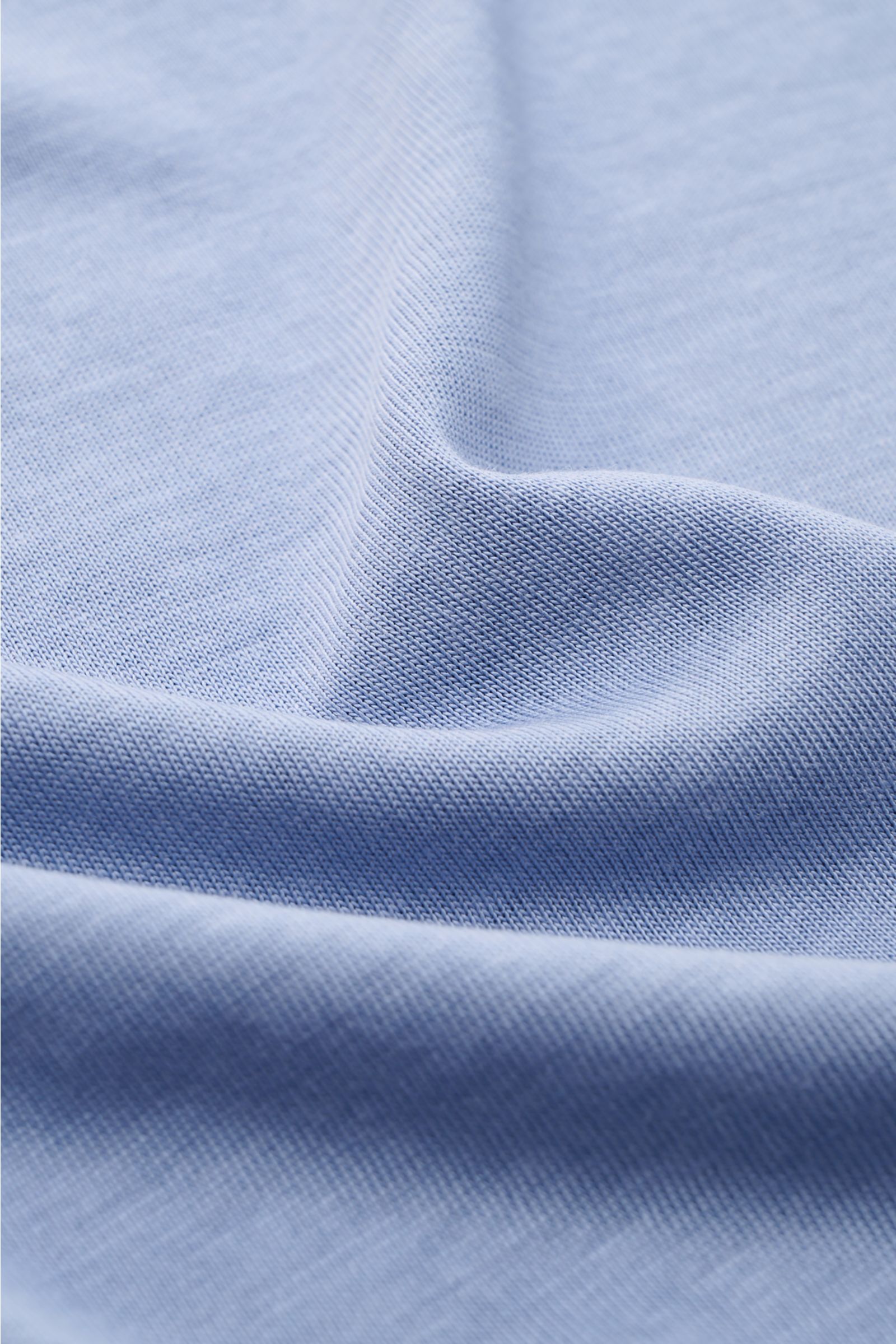 Close-up front view of the Altea Kurzarm-Strickpolo 'Pierre' rauchblau showing its fine knit texture and soft Lyocell-cotton mix fabric. Für ein sommerliches Gefühl: Das luftige Kurzarm-Strickpolo 'Pierre' von ALTEA aus softem Lyocell-Baumwoll-Mix in Fein