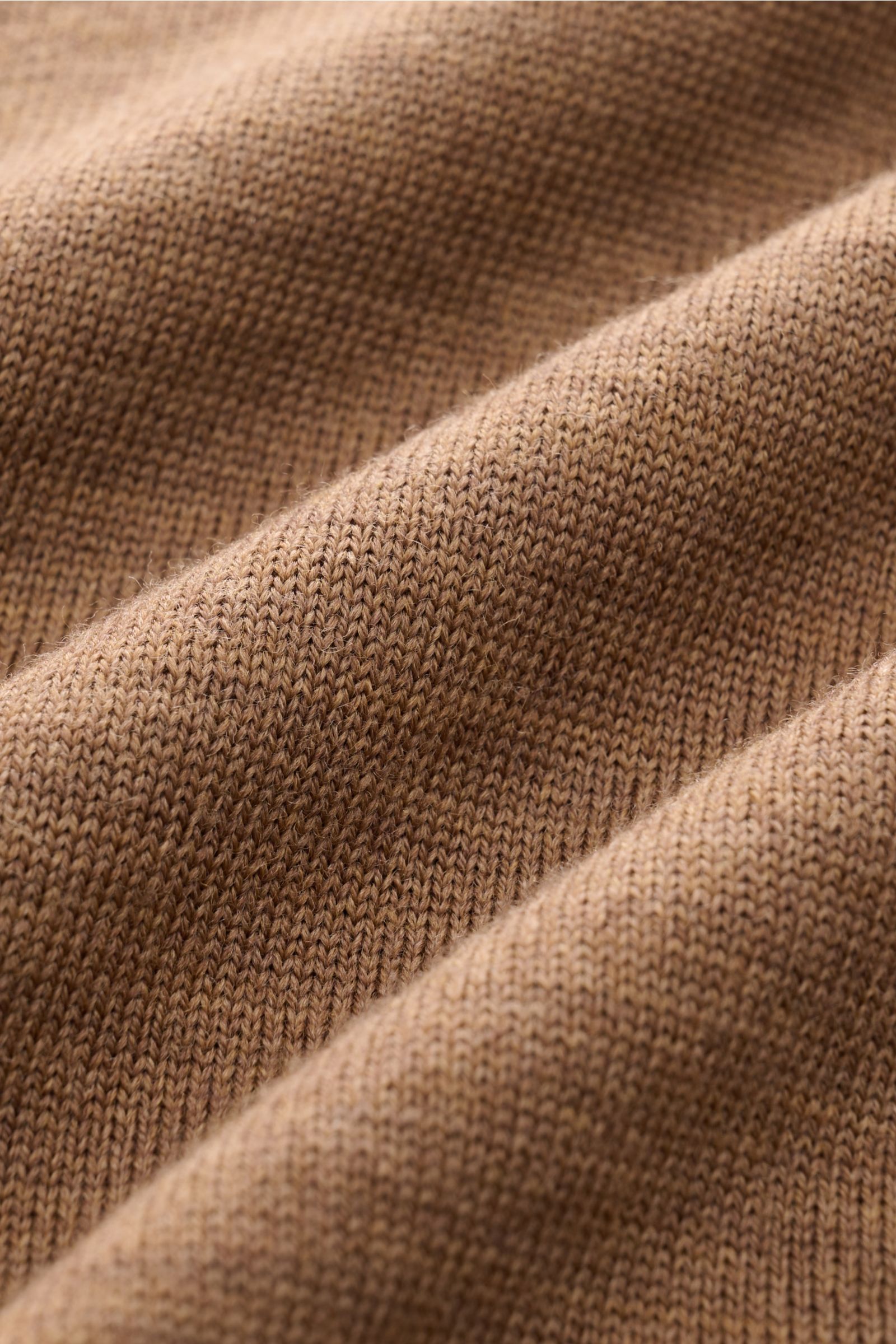 Close-up view of the finely knitted texture of the Aurélien Strickpolo 'Cashwool' braun, highlighting its soft, pure Merino wool fabric and warm brown color. Frühlings-Essential: Das Strickpolo von AURÉLIEN aus exklusiver 'Cashwool'-Merinowolle vereint ed