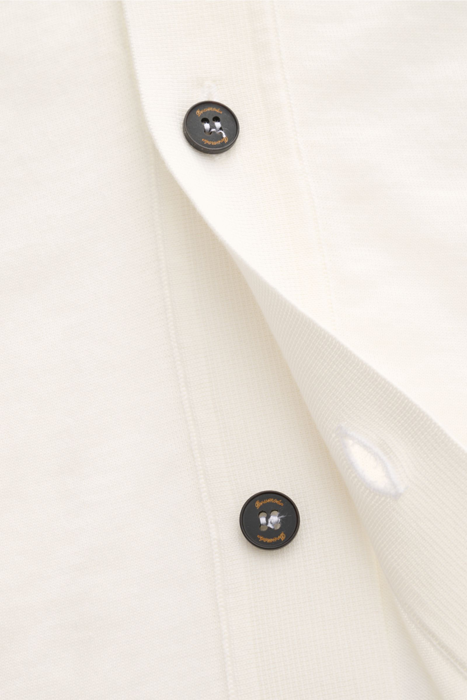 Close-up front view of Drumohr Short sleeve knit shirt off-white showing black buttons with logo, pure cotton, soft feel, regular fit, Cuban collar, straight hem. Stylish casual look: This knit shirt by DRUMOHR is a versatile piece for your spring wardrob
