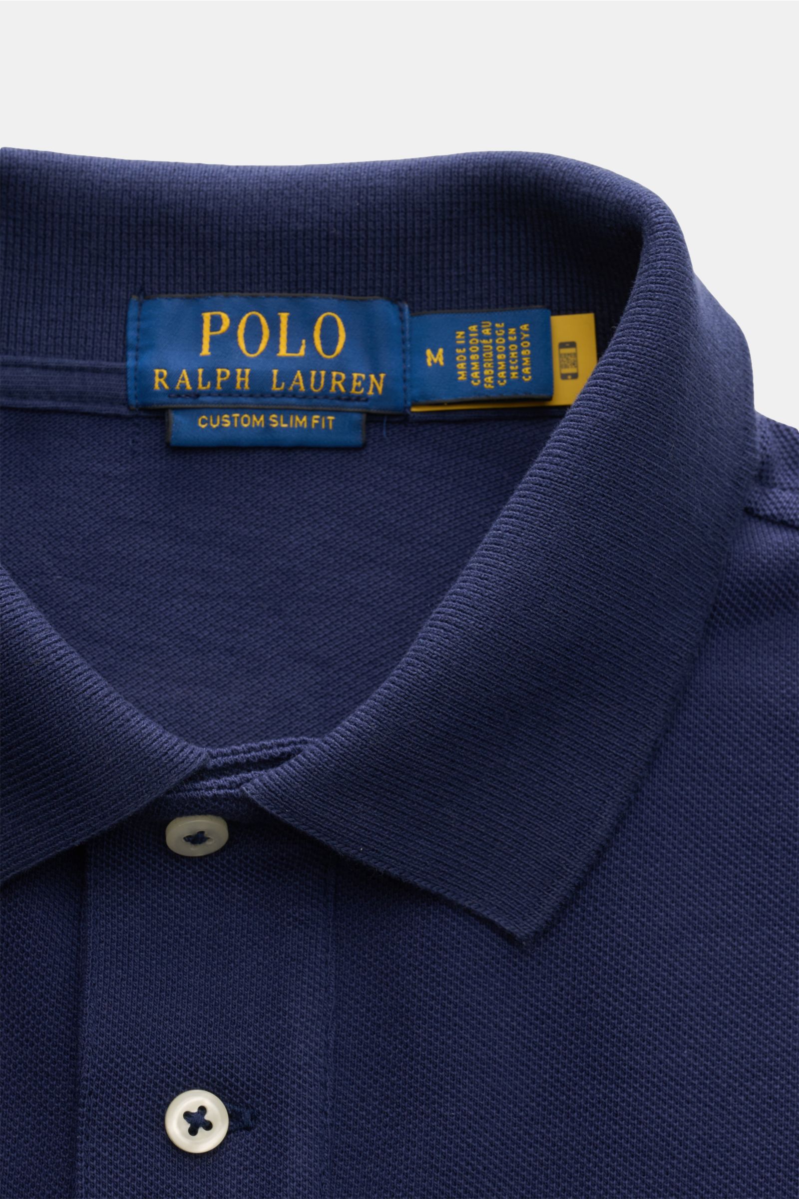 Close-up front view of the Polo Ralph Lauren Polo shirt navy, showing the collar, two-button placket, and fabric texture. The classic among polo shirts since 1972: The iconic pure cotton piqué model with the famous polo rider stitching on the chest wil
