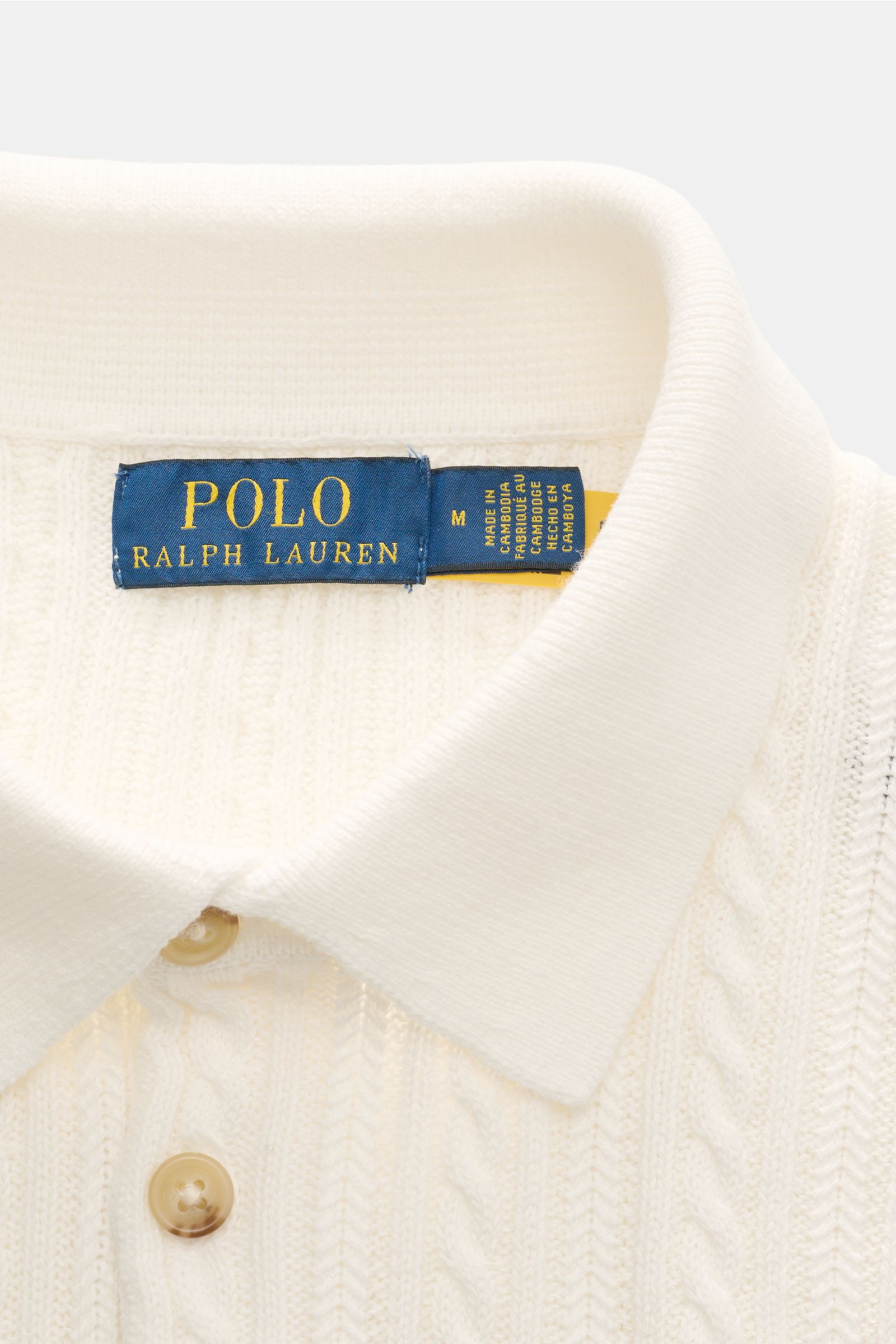 Close-up front view of Polo Ralph Lauren Short sleeve knit polo shirt off-white showing collar, buttons, and fine cable knit pattern.

Versatile classic: This short-sleeved knit polo by POLO RALPH LAUREN delivers maximum comfort and catches the eye on 