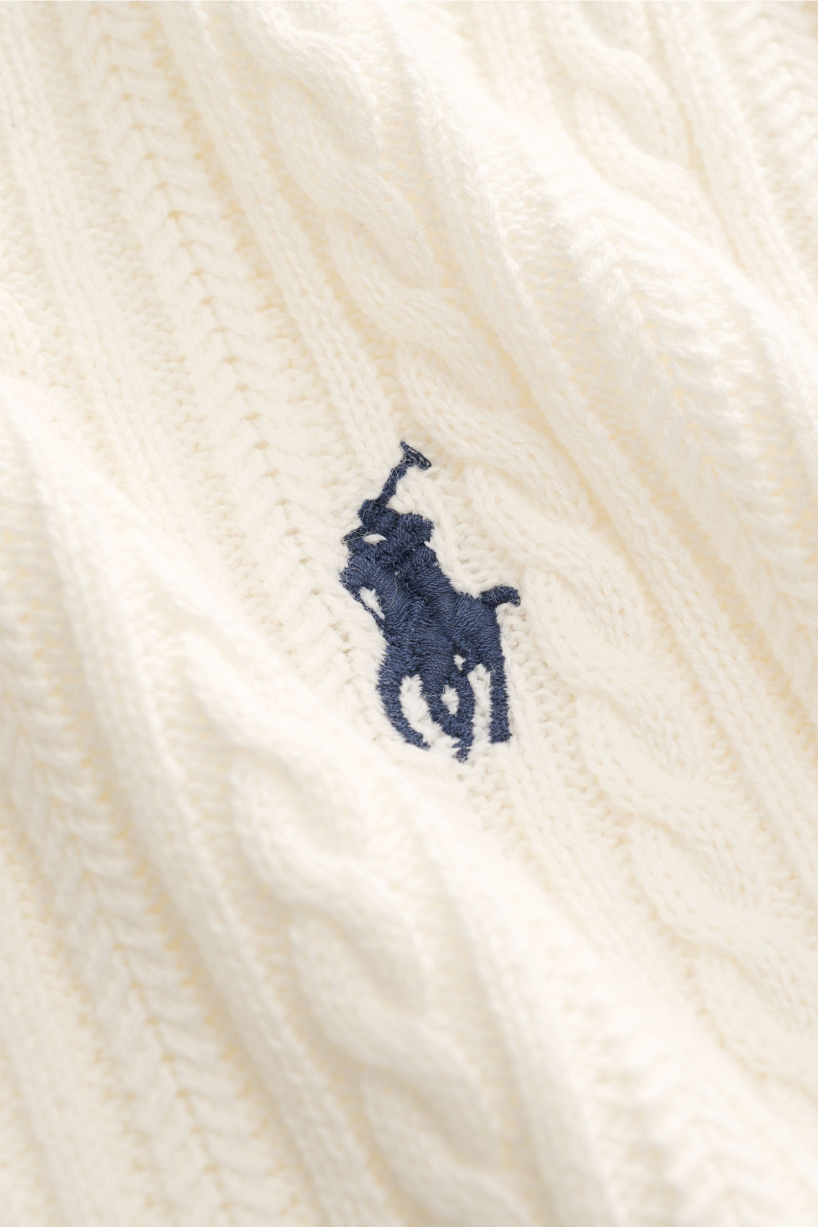 Close-up front view of the Polo Ralph Lauren Short sleeve knit polo shirt off-white showing fine cable knit pattern and navy logo stitching.

Versatile classic: This short-sleeved knit polo by POLO RALPH LAUREN delivers maximum comfort and catches the 