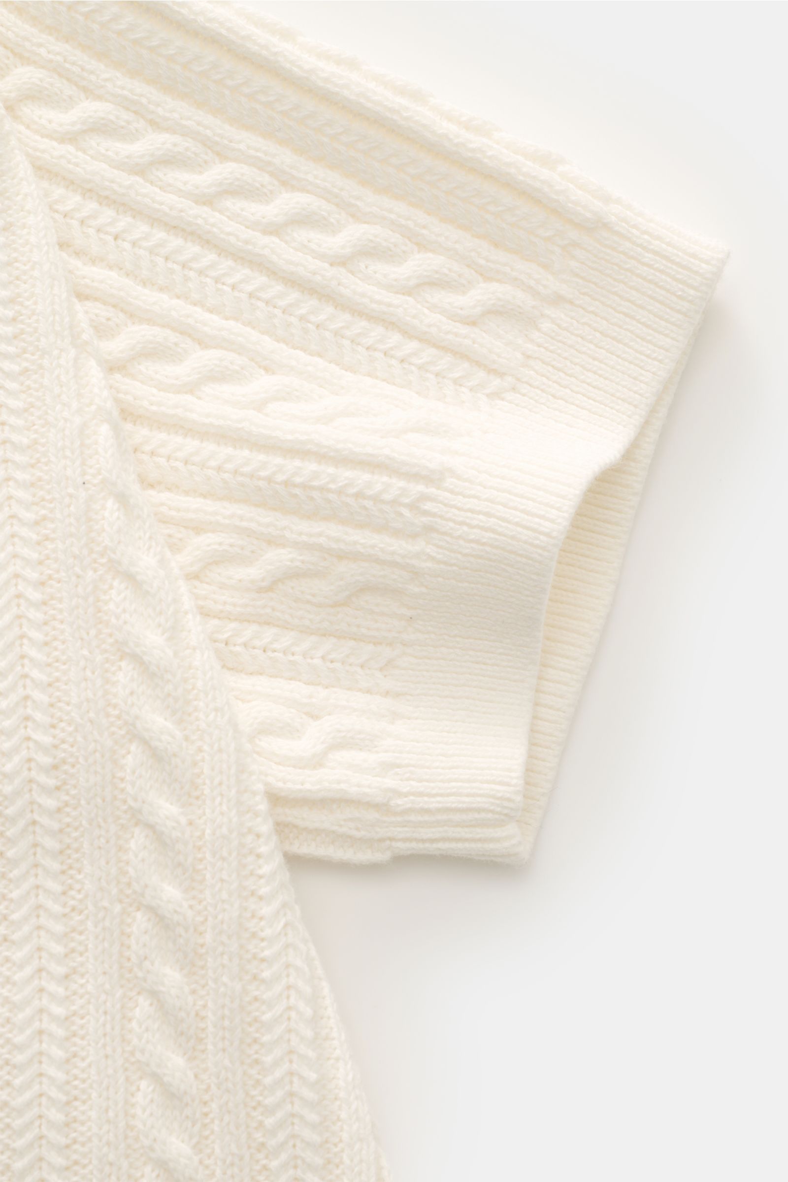 Close-up front-side view of Polo Ralph Lauren Short sleeve knit polo shirt off-white showing fine cable knit pattern and ribbed cuff.

Versatile classic: This short-sleeved knit polo by POLO RALPH LAUREN delivers maximum comfort and catches the eye on 