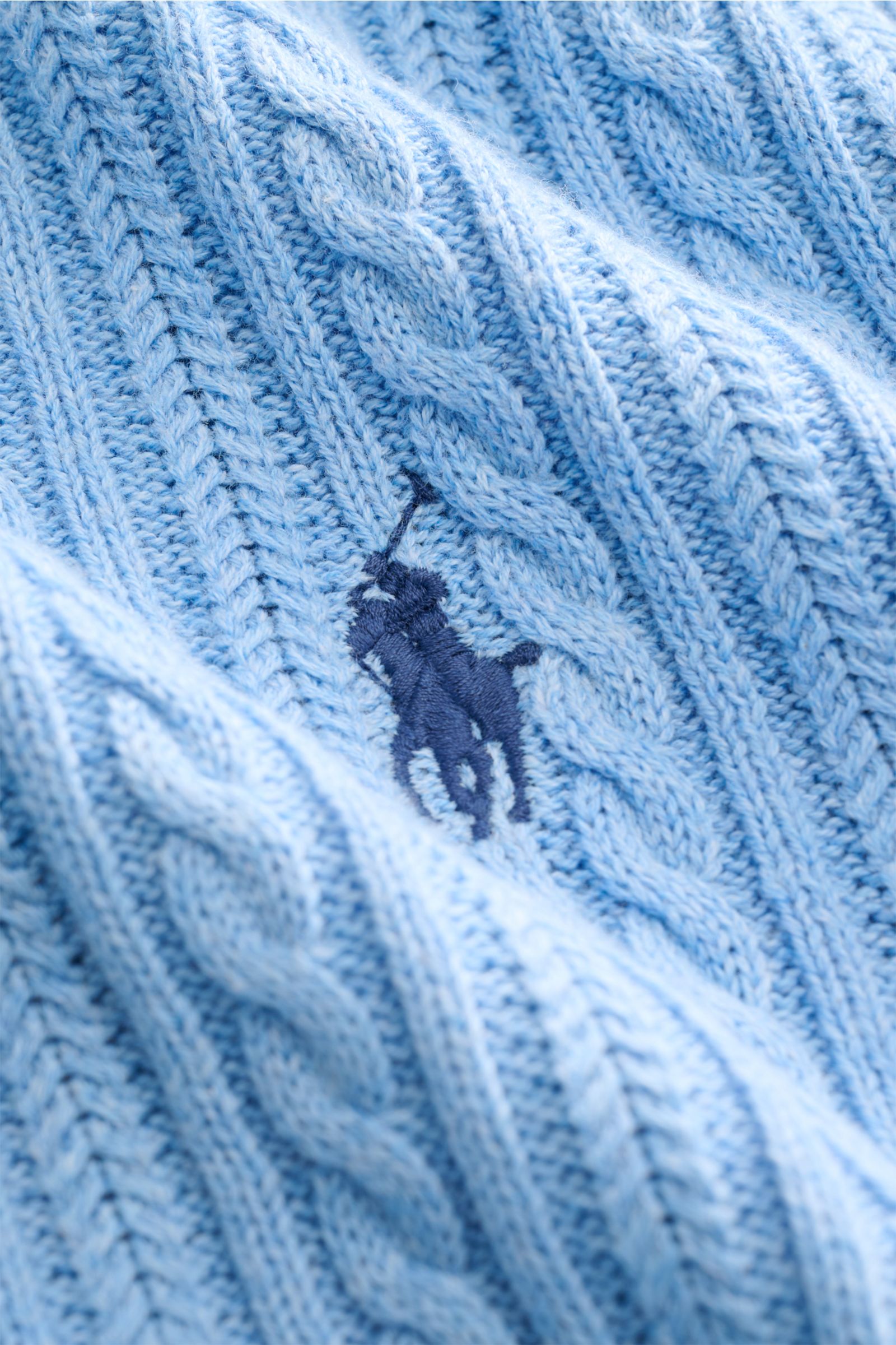Close-up top-down view of the fine cable knit pattern and signature logo on the light blue Polo Ralph Lauren Short sleeve knit polo.

Description: 
Versatile classic: This short-sleeved knit polo by POLO RALPH LAUREN delivers maximum comfort and catche