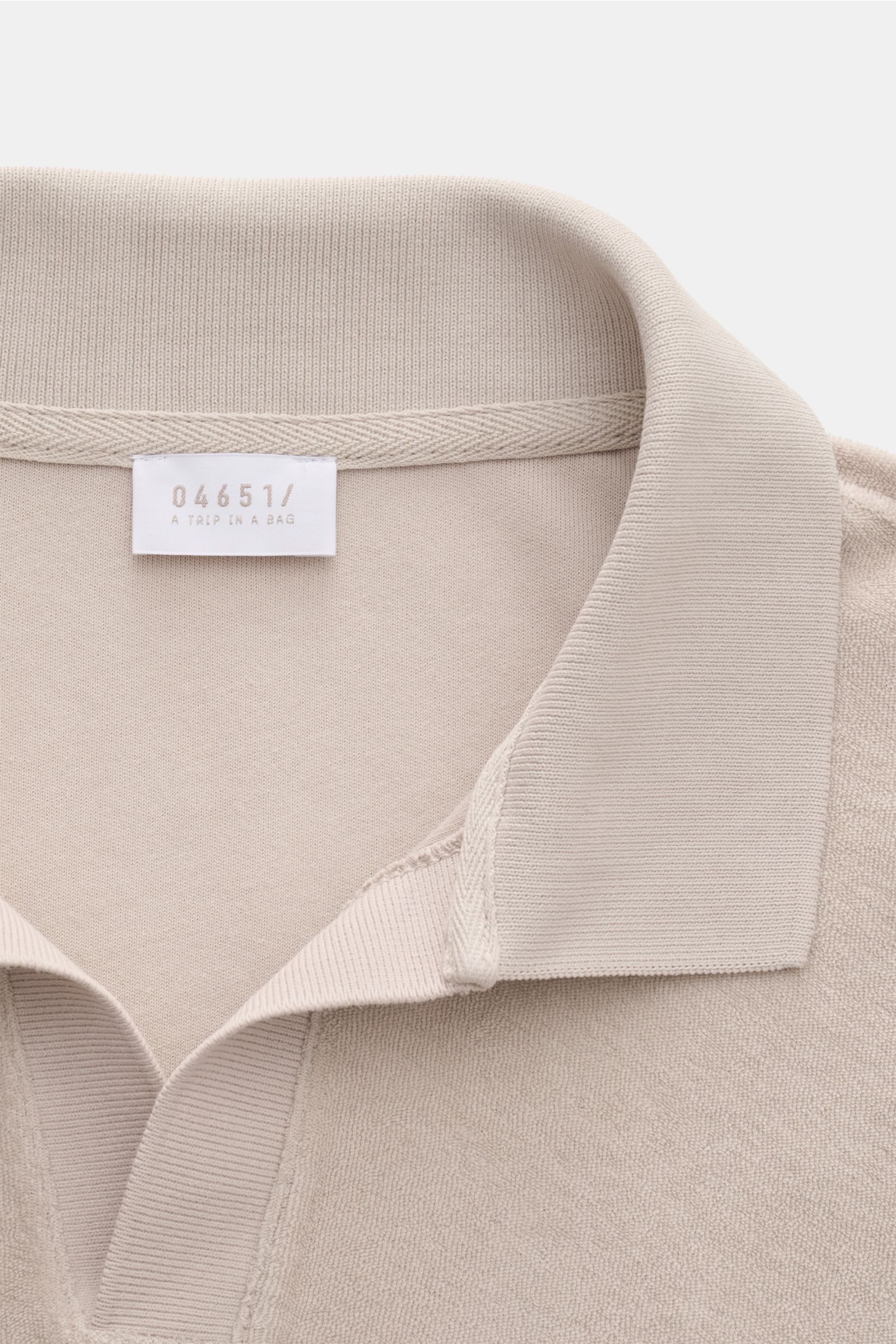 Close-up front view of the 04651/ A trip in a bag Terry polo shirt 'Terry Johnny' beige, showing the soft cotton terry fabric and signature collar.

Description: Holiday feel you can wear: This short sleeve polo shirt in comfortable cotton terry by 046