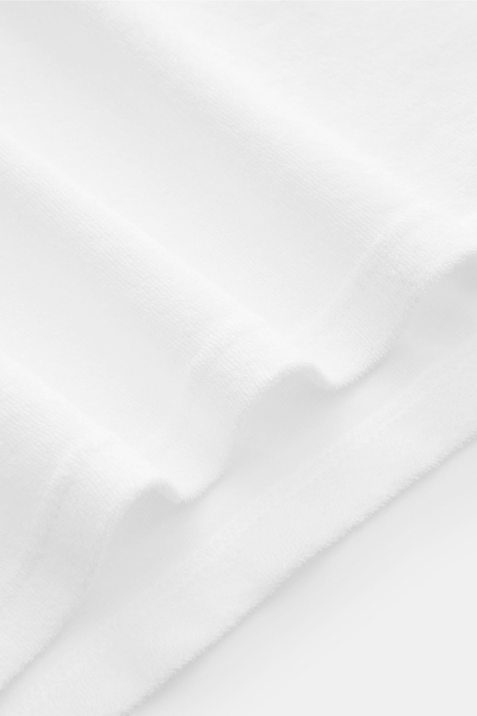 Close-up front-side view of the 04651/ A trip in a bag Terry polo shirt 'Terry Johnny' white showing soft cotton terry fabric and hem detail.

Description: Holiday feel you can wear: This short sleeve polo shirt in comfortable cotton terry by 04651/ A 