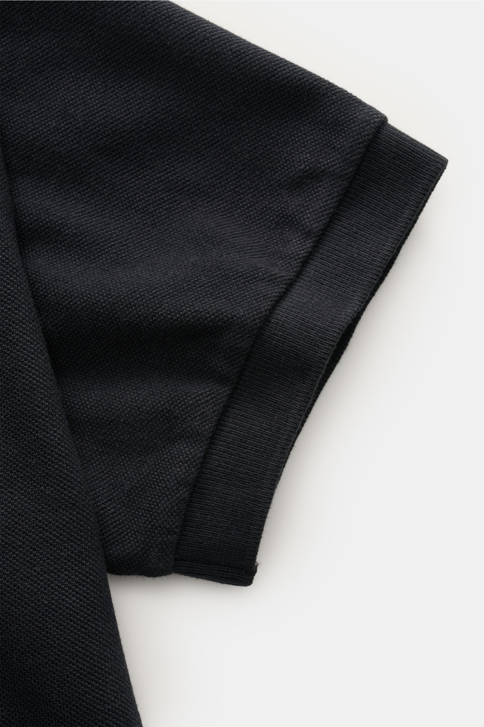 Close-up side view of the sleeve of the 04651/ A trip in a bag Polo shirt 'Johnny' anthracite in pure piqué cotton with ribbed cuff. 

For relaxed casual looks: 04651/ A TRIP IN A BAG brings a relaxed summer vibe to your wardrobe with this pure cotton 