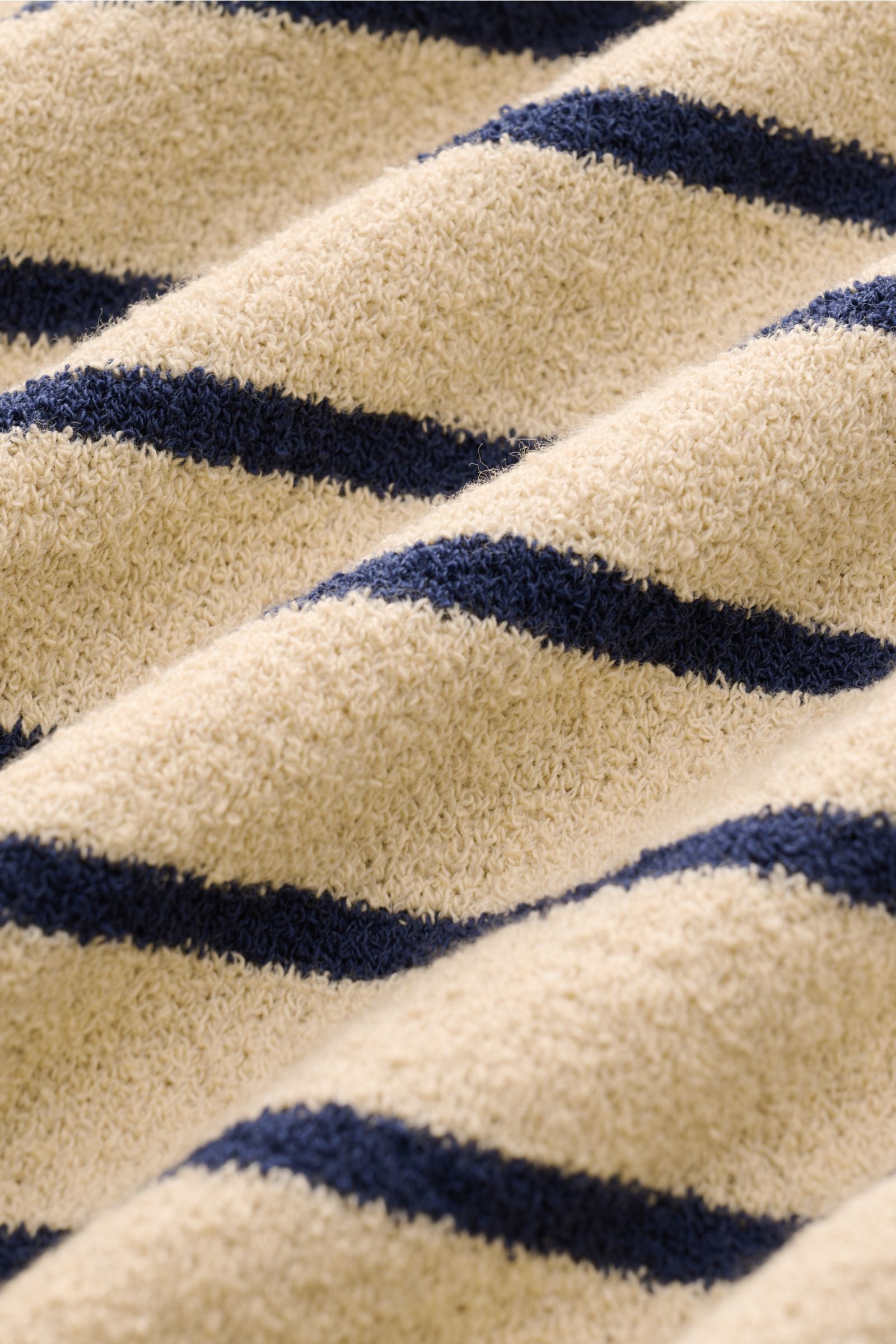 Nahaufnahme aus schräger Perspektive des Circolo 1901 Frottee-Kurzarm-Strickpolo beige/navy gestreift mit weicher, strukturierter Baumwolle und Microfaser.