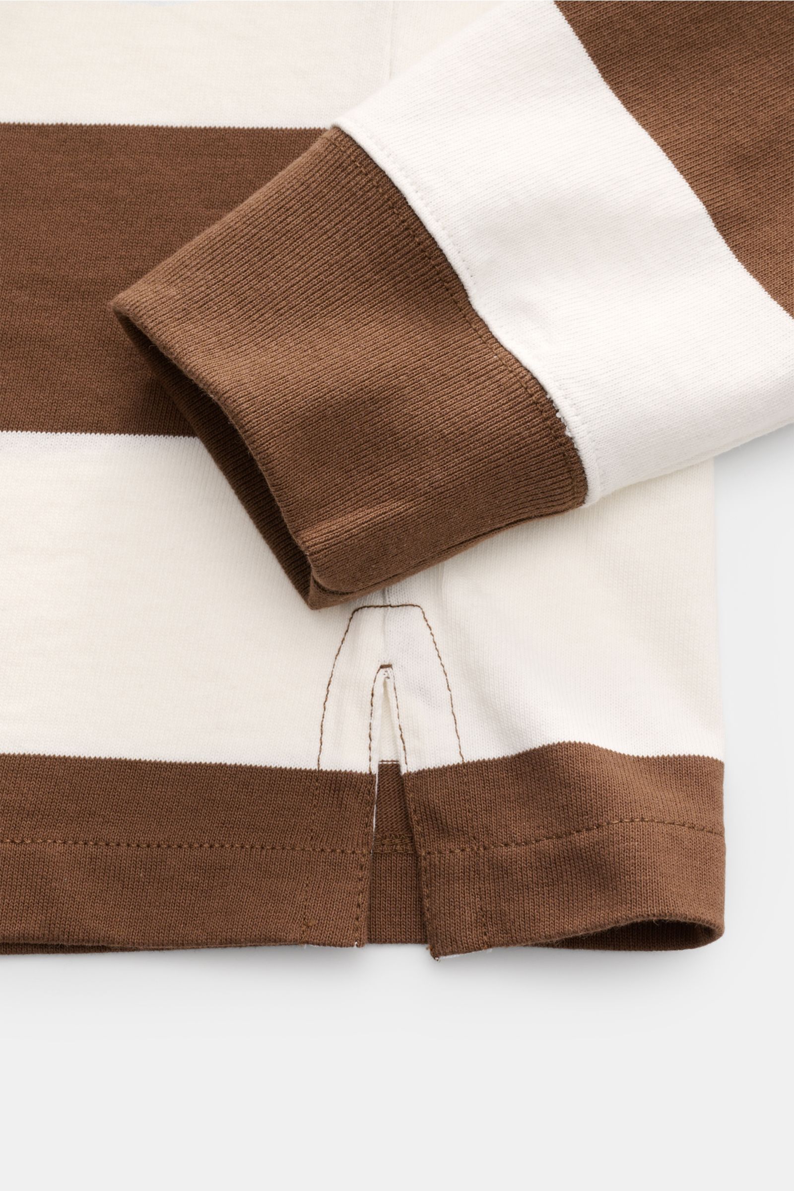 Nahaufnahme des Saums und Ärmelbündchens eines Polo Ralph Lauren Jersey Longsleeve-Poloshirts weiß/braun gestreift aus reiner Baumwolle.