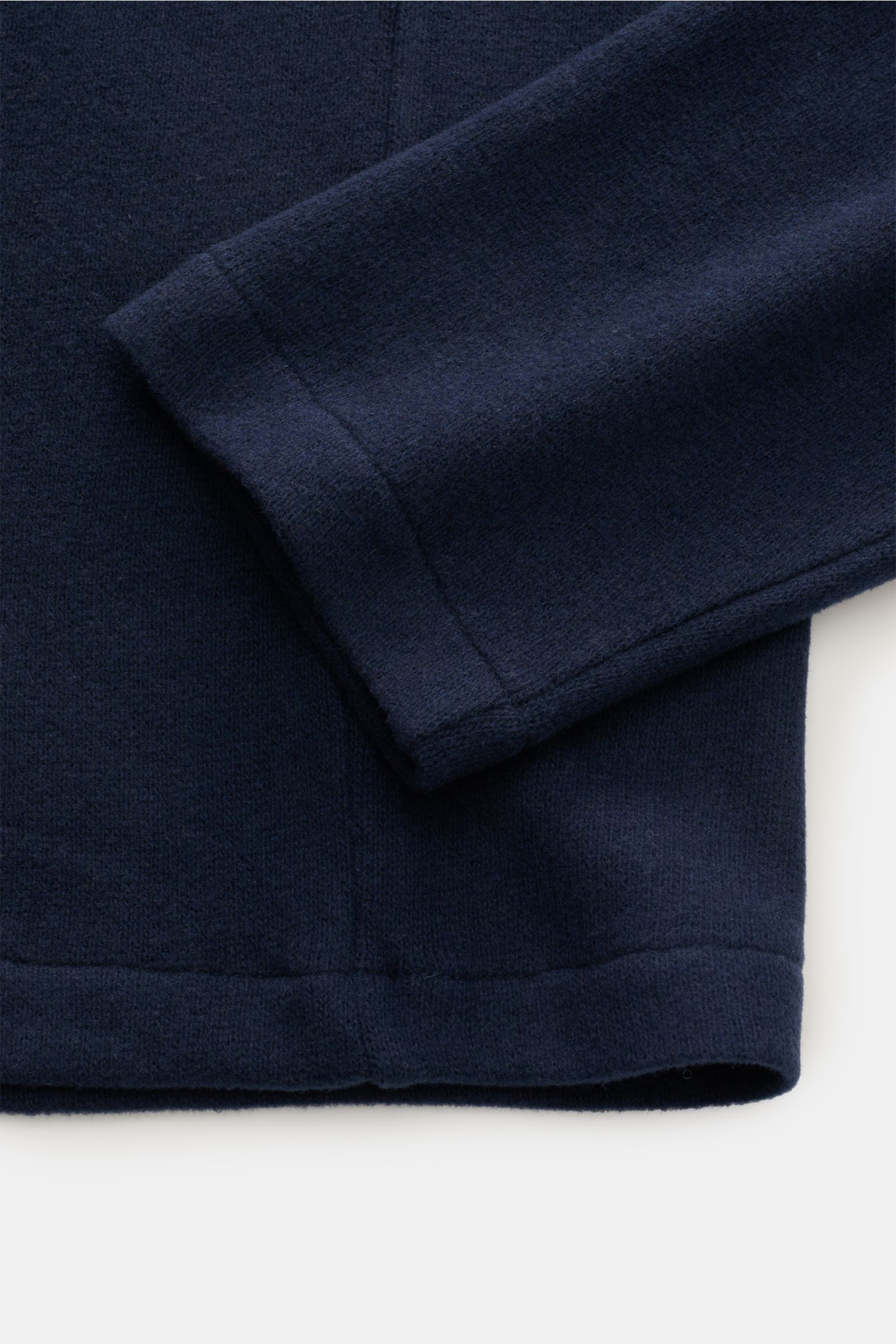 Close-up front view of the navy sleeve and hem of the Kiefermann Longsleeve-Poloshirt 'Tonin' navy, showing its soft, gently brushed cotton and microfiber jersey fabric with a regular fit, typical polo collar, and open collar placket. Schlicht im Desig