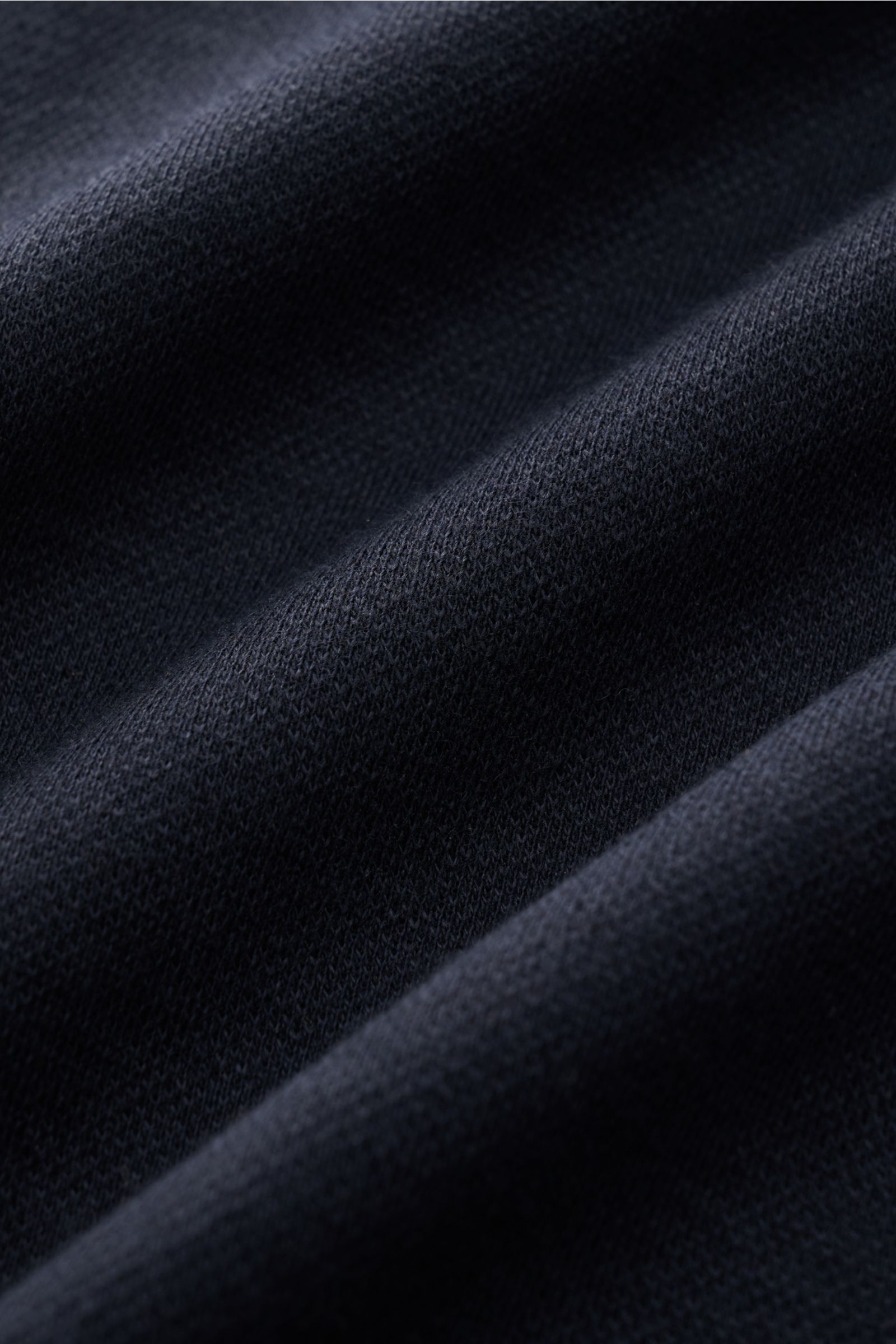 Nahaufnahme der feinen Piqué-Struktur des The Product is the Hero Longsleeve-Poloshirt navy aus Baumwoll-Cashmere-Mix.